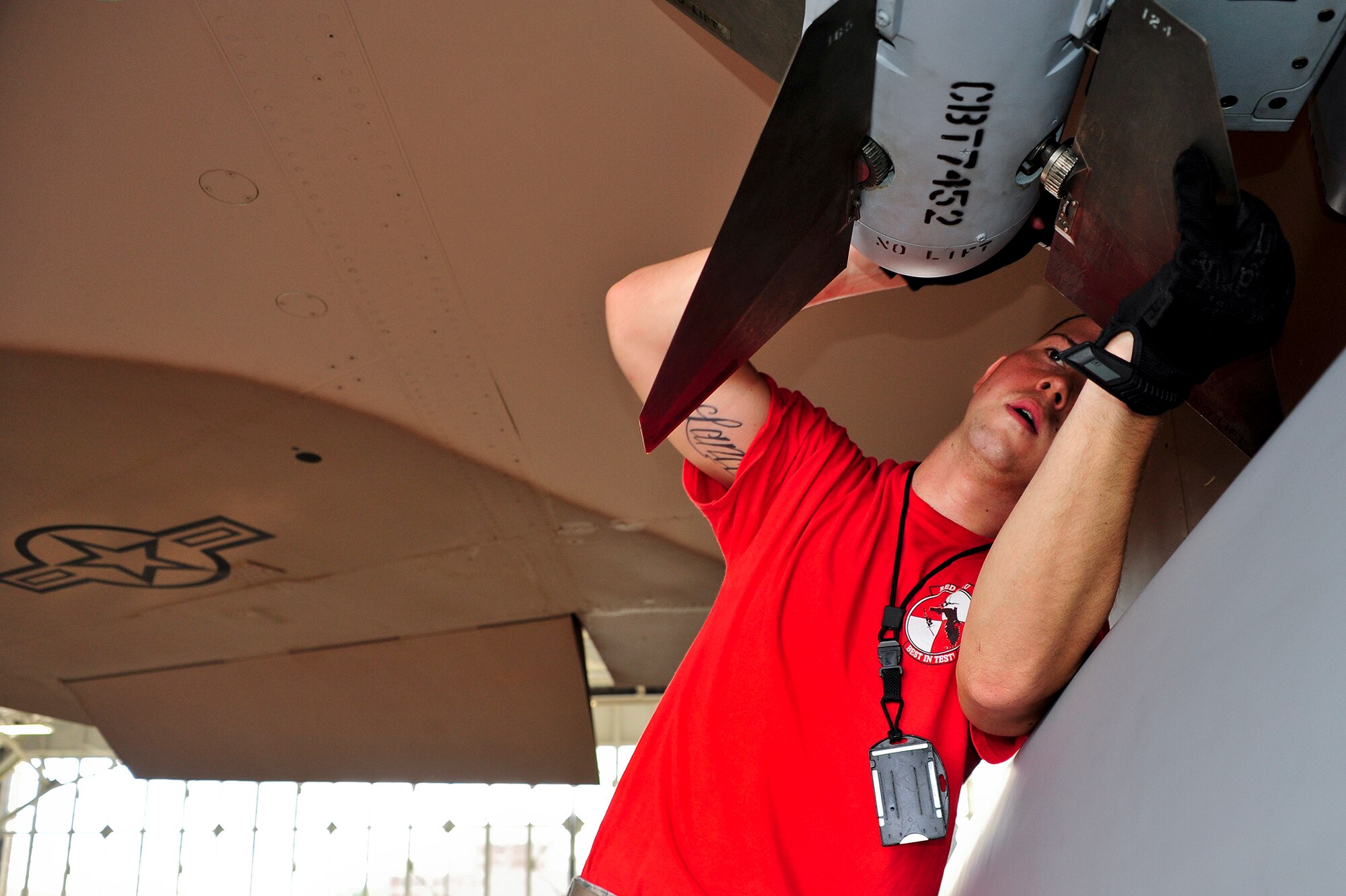 Senior Airman Lance O’Rourke, of the 96th Aircraft Maintenance Squadron Red, position an AIM-120 missile for loading onto an F-15 Eagle, during the 96th Maintenance Group’s quarterly weapons load crew competition Sept. 26 at Eglin Air Force Base, Fla. Other members on O'Rourke's team were Staff Sgt Isaac Tolentino and Airman 1st Class Colin Reeder. (U.S. Air Force photo/Ilka Cole)