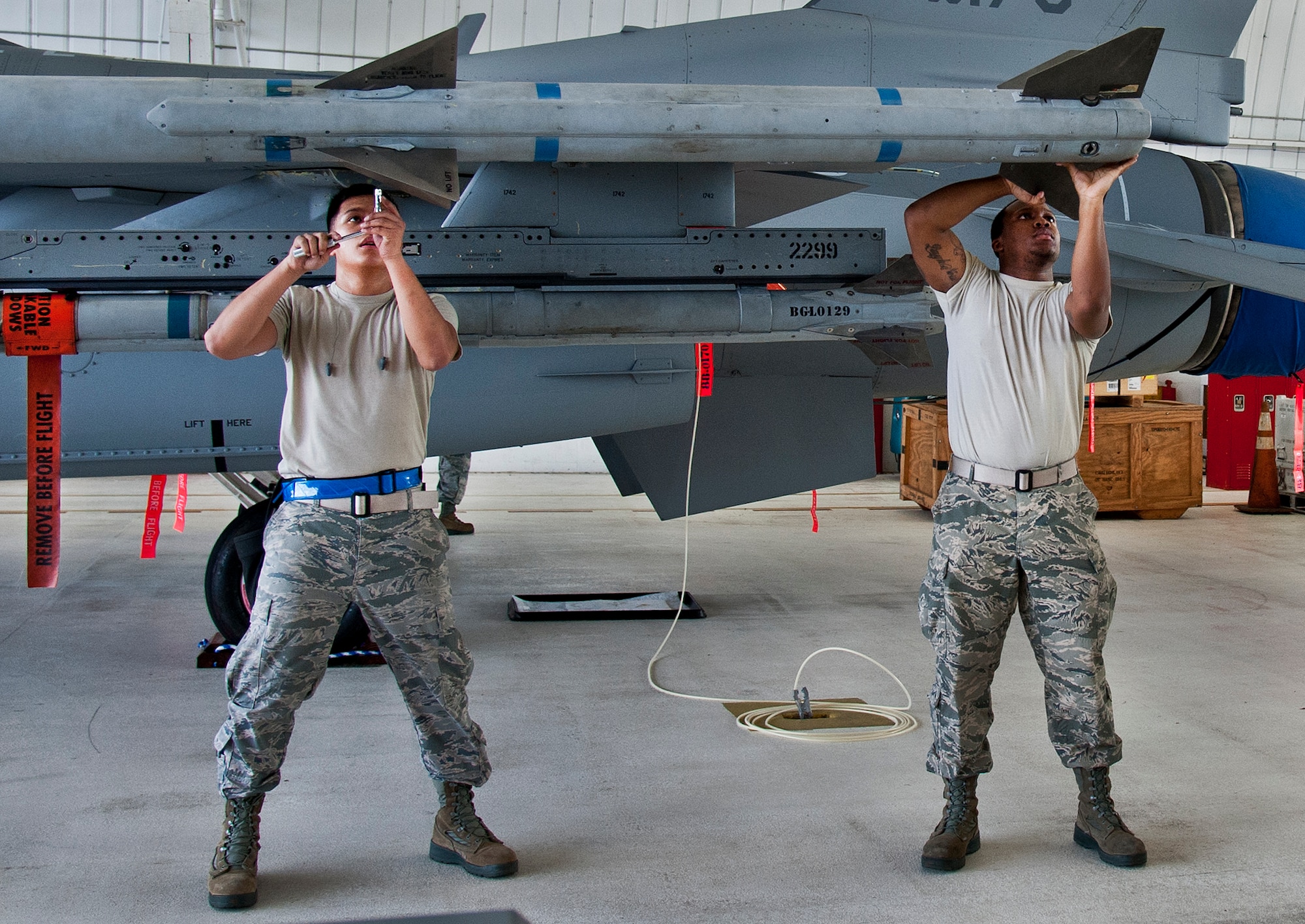 Airmen 1st Class Frederick Guaren and Troy Carpenter, of the 96th Aircraft Maintenance Squadron Blue, secure AIM-120 wings and fins for loading onto an F-16 Fighting Falcon, during the 96th Maintenance Group’s quarterly weapons load crew competition Sept. 26 at Eglin Air Force Base, Fla. (U.S. Air Force photo/Chrissy Cuttita)