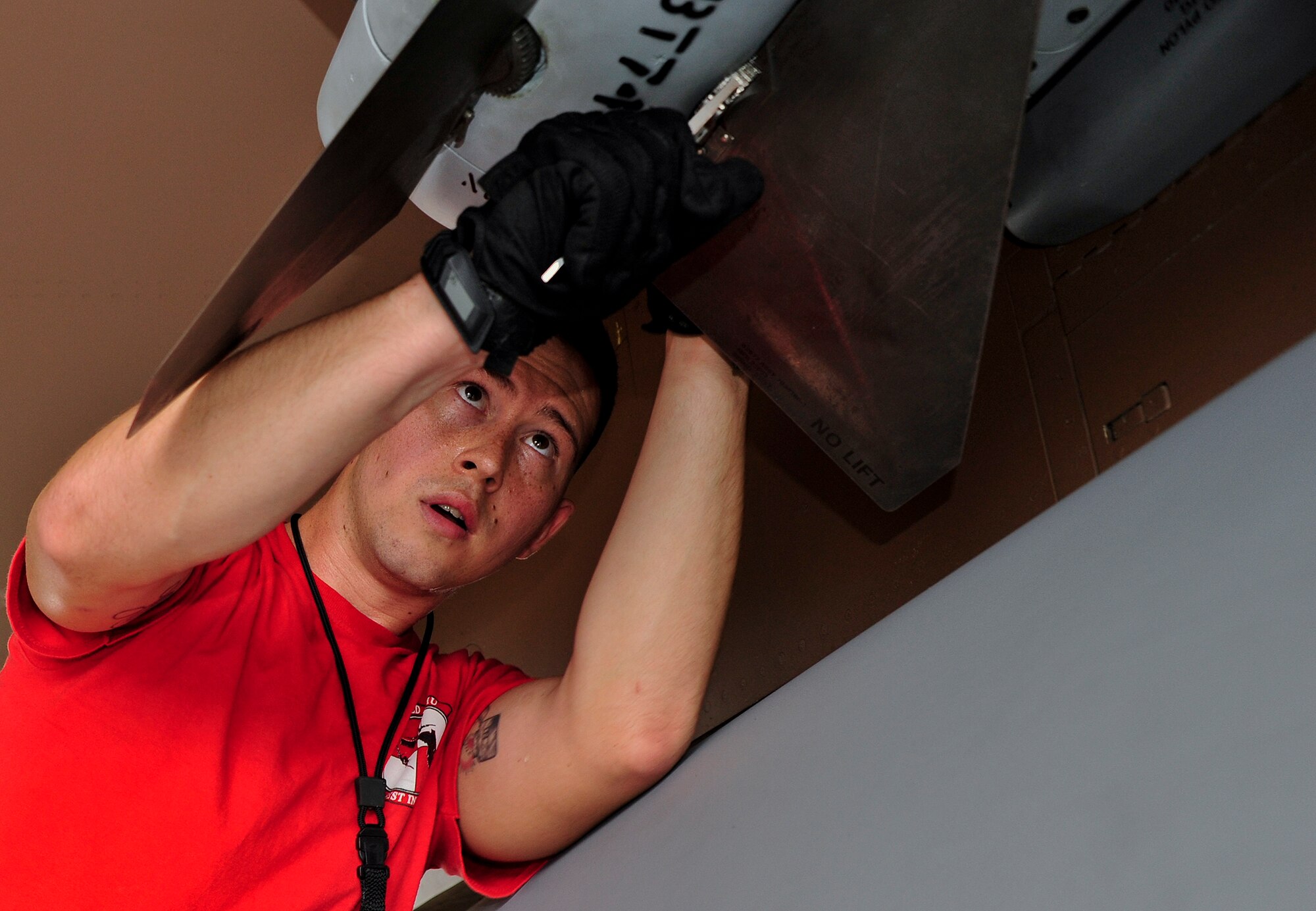 Senior Airman Lance O’Rourke, of the 96th Aircraft Maintenance Squadron Red, position an AIM-120 missile for loading onto an F-15 Eagle, during the 96th Maintenance Group’s quarterly weapons load crew competition Sept. 26 at Eglin Air Force Base, Fla. Other members on O'Rourke's team were Staff Sgt Isaac Tolentino and Airman 1st Class Colin Reeder.  (U.S. Air Force photo/Ilka Cole)