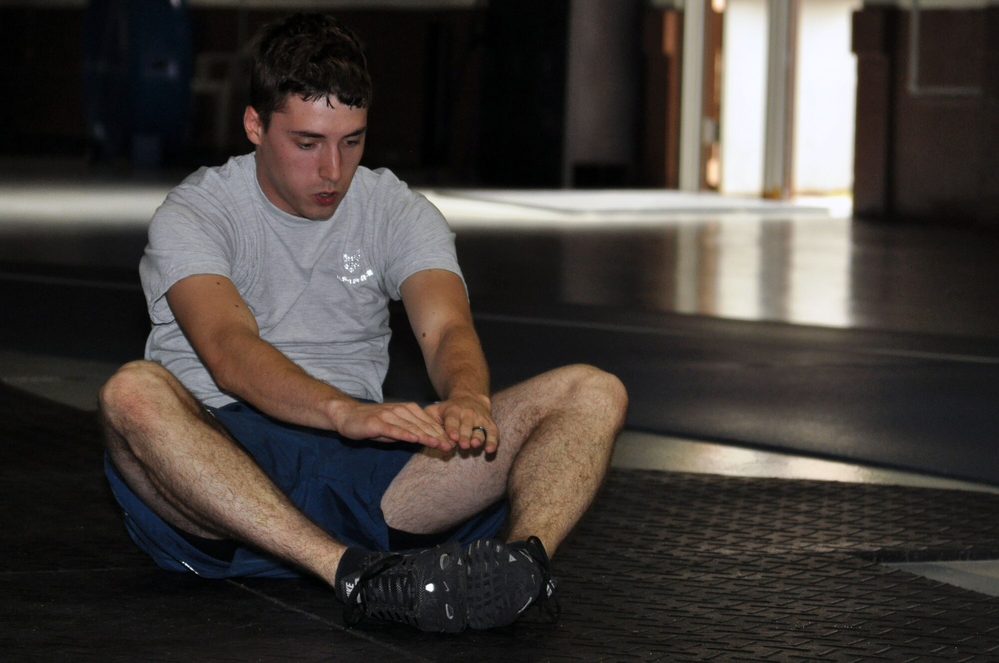 Airman 1st Class Cody Austin, 338th Combat Training Squadron, performs a sit-up Sept. 26 at the Offutt Field House during Comprehensive Airmen Fitness Day.  Participants of CAF Day had the opportunity to demonstrate their fitness level during activities such as a two-mile warrior run, circuit workout or CrossFit challenge. (U.S. Air Force photo Staff Sgt. Rachelle Blake)