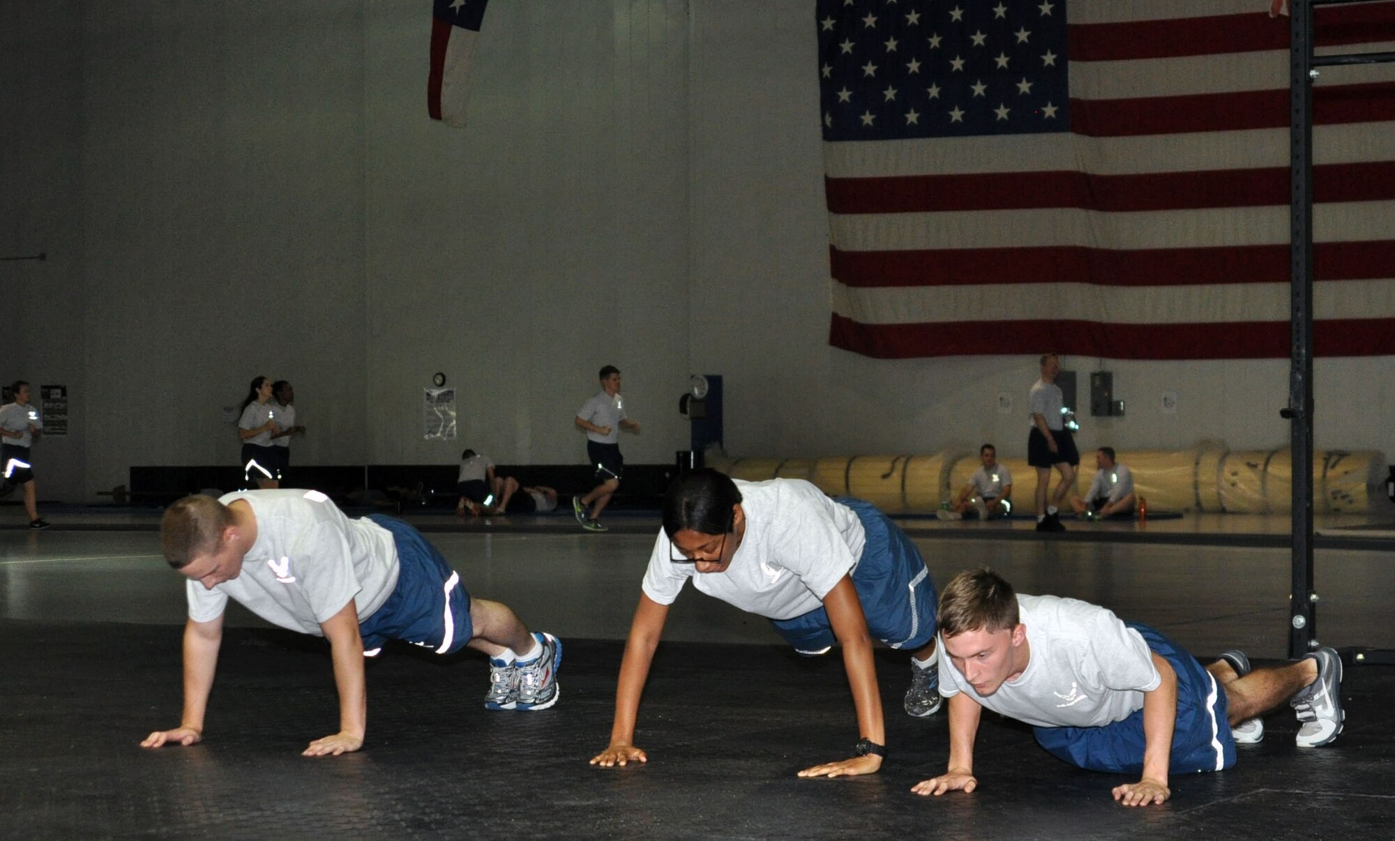 Member of Team Offutt perform push-ups Sept. 26 at the Offutt Field House during Comprehensive Airmen Fitness Day.  The Airmen are participating in the CrossFit workout of the day ran by the CrossFit Team Offutt Tactical Fitness Coaches. (U.S. Air Force photo Staff Sgt. Rachelle Blake)