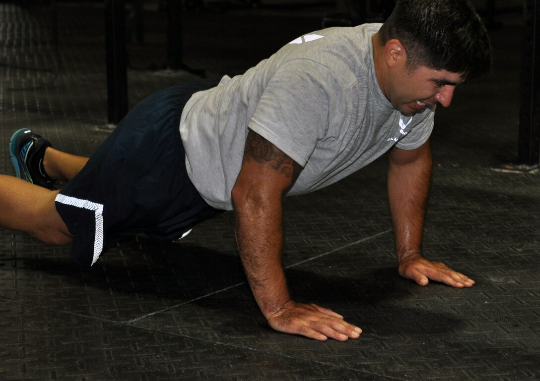 U.S. Air Force Staff Sgt. Valentin Larios, 55th Operations Support Squadron, performs a burpee Sept. 26 at the Offutt Field House during Comprehensive Airmen Fitness Day.  The goal of this CAF Day was to ensure the members of the 55th Wing were physically ready to accomplish the mission no matter what. (U.S. Air Force photo Staff Sgt. Rachelle Blake)