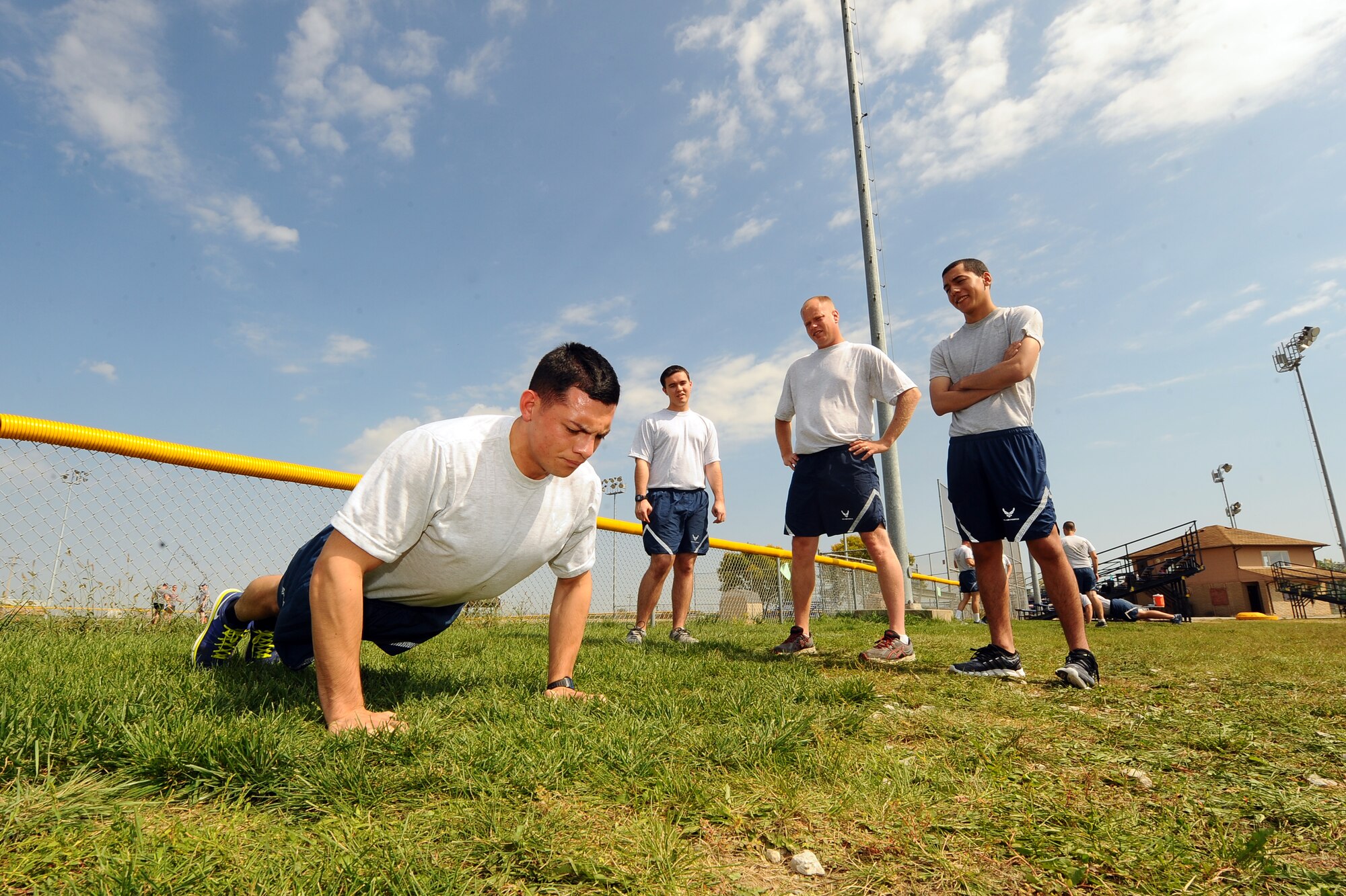 U.S. Air Force Airman First Class Edward Garcia, 338th Combat Training Squadron data operator, performs a push-up as part of the “Circuit Work-It” portion of Comprehensive Airman Fitness Day Sept. 26 outside the softball field.  The CAF day featured numerous events at different locations. (U.S. Air Force photo by Josh Plueger/Released)