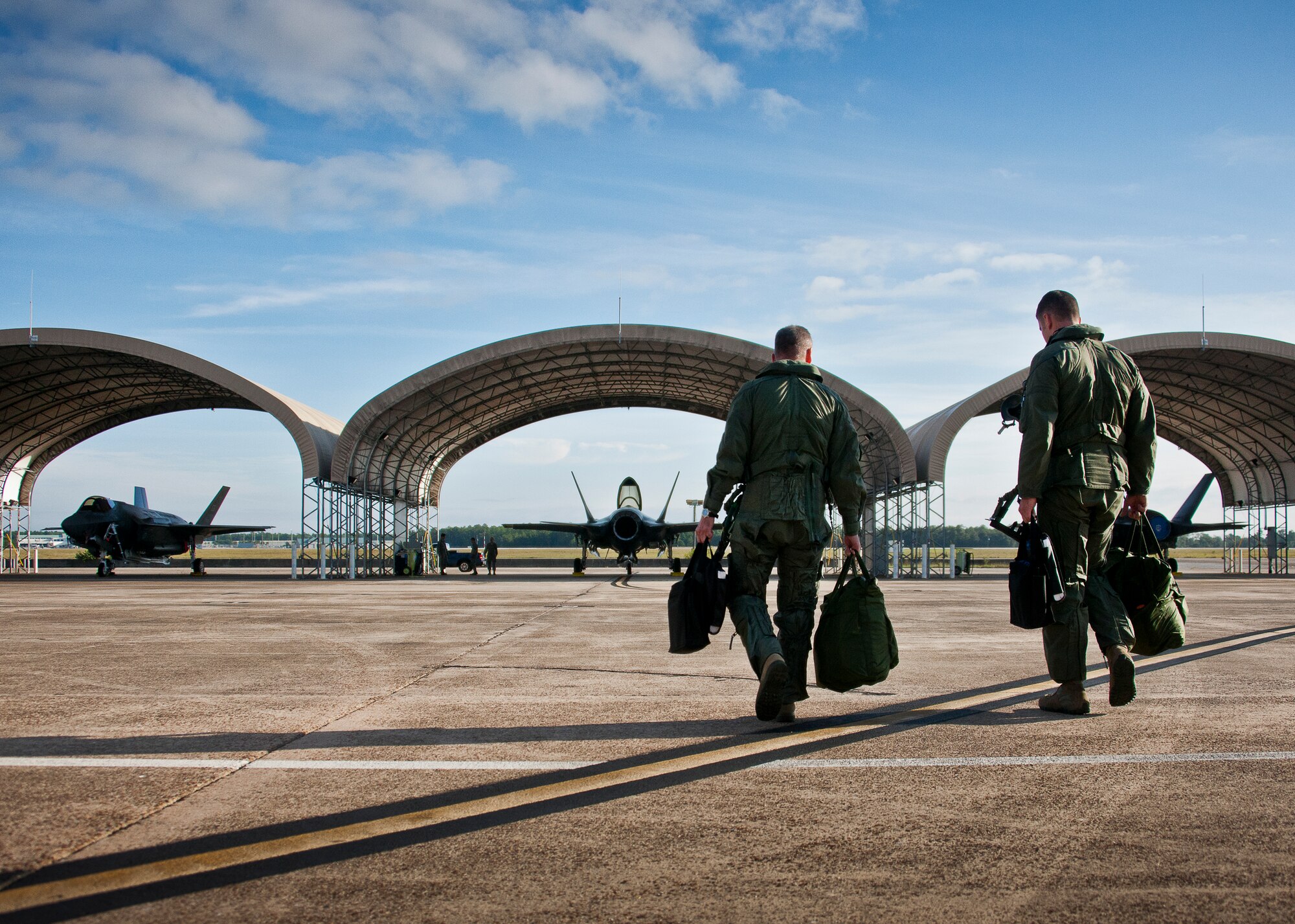 Maj. Gen. Jay Silveria, U. S. Air Force Warfare Center commander, walks out to his F-35A Lightning II with Lt. Col. Matt Renbarger, the 58th Fighter Squadron commander, before his final qualification flight Sept. 26 at Eglin Air Force Base, Fla.  Silveria became the first general officer in the Department of Defense to qualify in the fifth generation fighter.  He completed his training with back-to-back flights and hot pit refueling.  (U.S. Air Force photo/Samuel King Jr.)