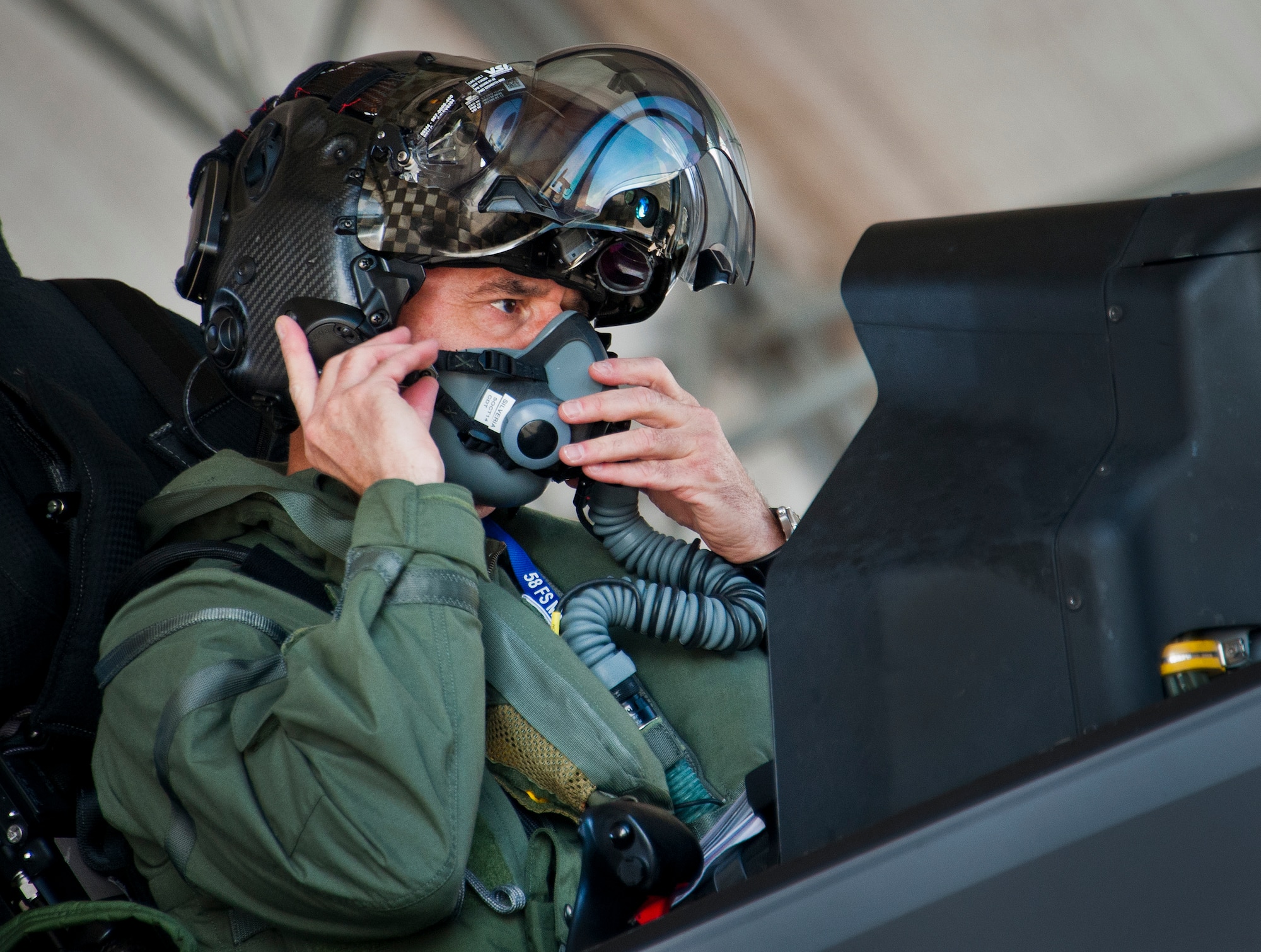 Maj. Gen. Jay Silveria, U. S. Air Force Warfare Center commander, connects his oxygen mask prior to his final qualifying flight in the F-35A Lightning II Sept. 26 at Eglin Air Force Base, Fla.  Silveria became the first general officer in the Department of Defense to qualify in the fifth generation fighter.  He completed his training with back-to-back flights and hot pit refueling.  (U.S. Air Force photo/Samuel King Jr.)