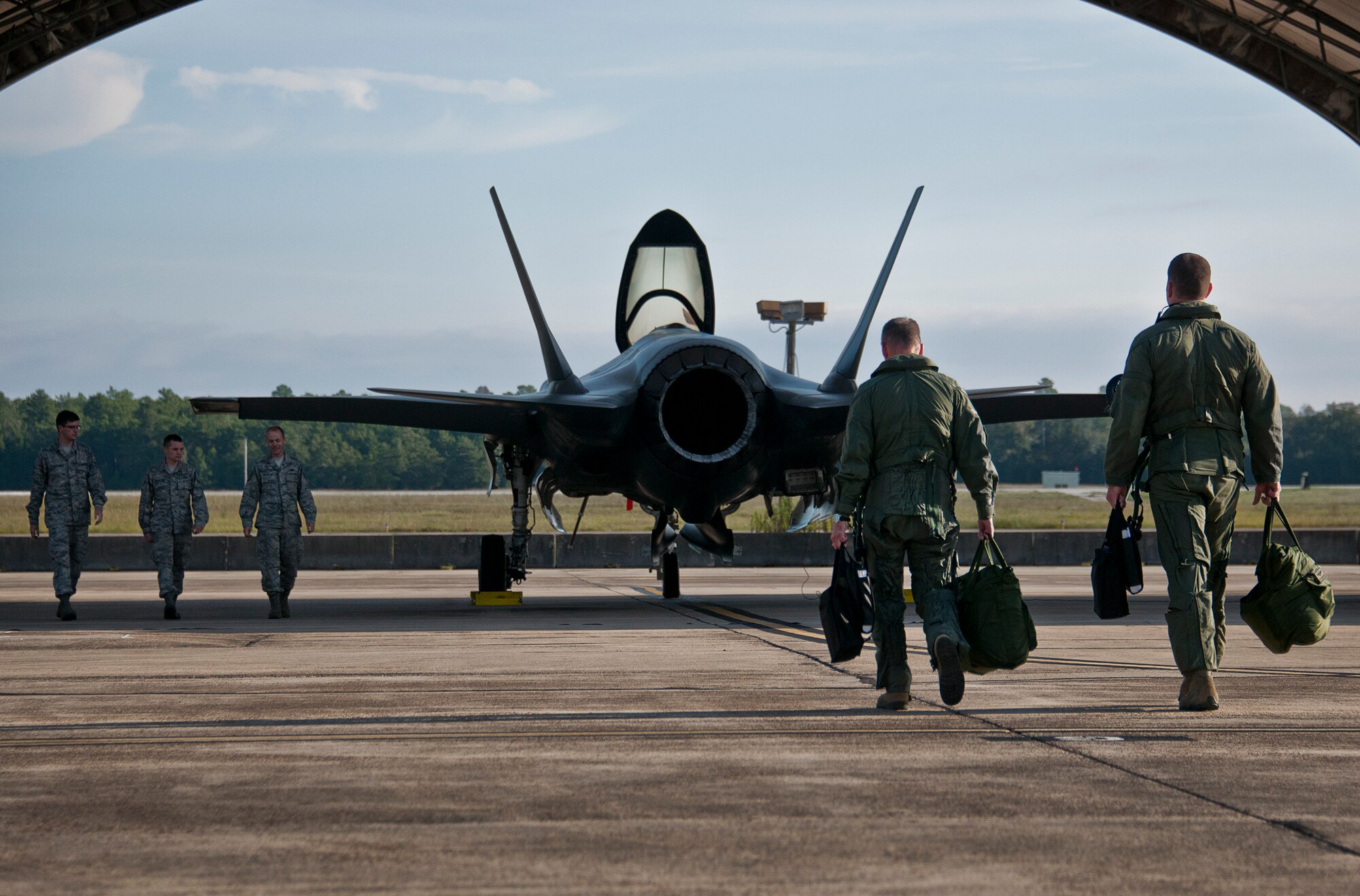 Maj. Gen. Jay Silveria, U. S. Air Force Warfare Center commander, walks out to his F-35A Lightning II with Lt. Col. Matt Renbarger, the 58th Fighter Squadron commander, before his final qualification flight Sept. 26 at Eglin Air Force Base, Fla.  Silveria became the first general officer in the Department of Defense to qualify in the fifth generation fighter.  He completed his training with back-to-back flights and hot pit refueling.  (U.S. Air Force photo/Samuel King Jr.)