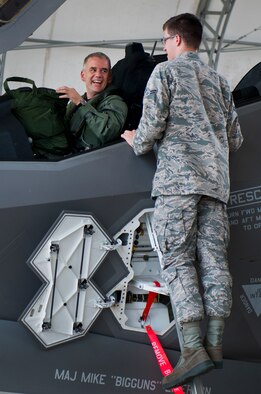 Maj. Gen. Jay Silveria, U. S. Air Force Warfare Center commander, has a laugh with Airman 1st Class John Patterson, 33rd Aircraft Maintenance Squadron, after completing his final qualifying flight in the F-35A Lightning II Sept. 26 at Eglin Air Force Base, Fla.  Silveria became the first general officer in the Department of Defense to qualify in the fifth generation fighter.  He completed his training with back-to-back flights and hot pit refueling.  (U.S. Air Force photo/Samuel King Jr.)