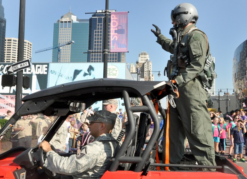 Master Sgt. John De La Rosa drives Tech. Sgt. Christopher Kitts, both from the 509th Bomb Wing, as Kitts waves at crowds during the American Royal Parade September 27 in Kansas City. (Air Force photo by Tech. Sgt. Emily F. Alley)