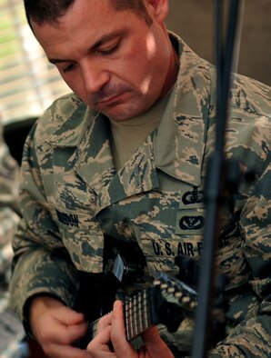 U.S. Air Force Tech. Sgt. Daniel Bragdon, USAF Heartland of America Band guitarist, rehearses for an upcoming performance.  Members of the band not only play their respective instruments, but are also responsible for several additional duties. (U.S. Air Force photo by Jeff W. Gates/Released)