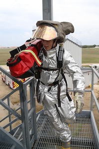 Senior Airman Justin Phelps races up the stairs while carrying a bag of hoses during the firefighter fitness challenge portion of the Battle of the Badges competition Sept. 27 at Joint Base San Antonio-Randolph’s Camp Talon. Firefighters and security forces members from Joint Base San Antonio locations have competed in Battle of the Badges for the past three years. The initiative was designed to build stronger bonds between the agencies and has become a tradition for the unit members, their families and friends.  Phelps is a JBSA Fire Emergency Services firefighter. (U.S. Air Force photo by Johnny Saldivar)