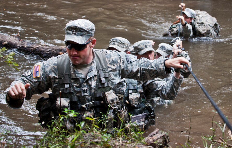 Soldiers from the 6th Ranger Training Battalion cross the water and climb up the bank to reach a memorial on Eglin Air Force Base, Fla., for the four fallen Rangers who lost their lives Feb. 16, 1995.  More than 40 Soldiers participated in the excursion Sept. 25 that followed in the footsteps of the tragic squad to learn from their experience and understand what took place that night almost 20 years ago.  (U.S. Air Force photo/Samuel King Jr.)