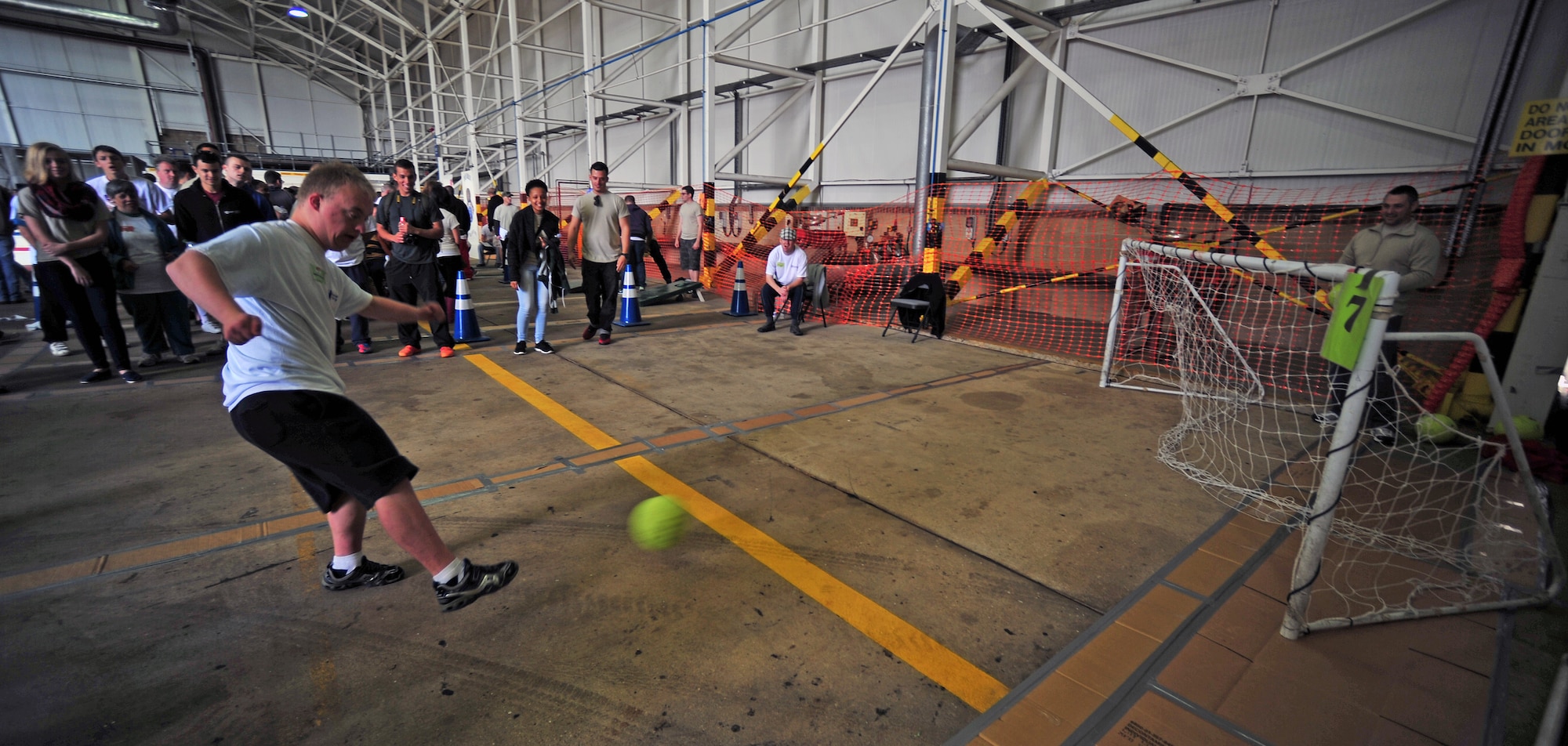 A Joan Mann Special Sports Day athlete kicks a ball during the JMSSD event Sept. 27, 2014, on RAF Mildenhall, England. The event began 33 years ago with Joan Mann, a Ministry of Defence employee who worked with the public affairs office on RAF Mildenhall.  She wanted to find a way to bring local community and military members together to work with special-needs citizens. (U.S. Air Force photo/Senior Airman Christine Griffiths/Released) 
