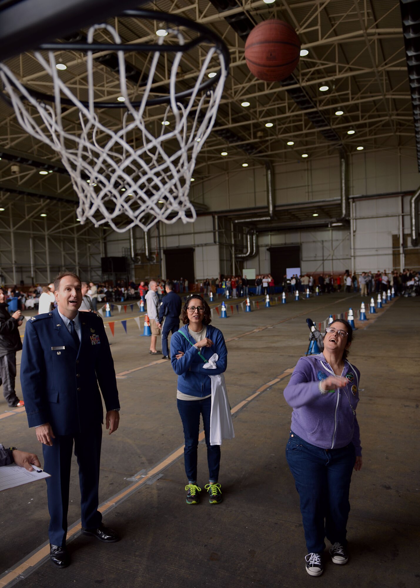 Lynda Sebastian, right, Joan Mann Special Sports Day athlete, shoots  a basket Sept. 27, 2014, on RAF Mildenhall, England. The JMSSD is an Olympic-style event featuring a variety of sporting activities for more than 250 special-needs athletes from across England. (U.S. Air Force photo/Airman 1st Class Preston Webb/Released)