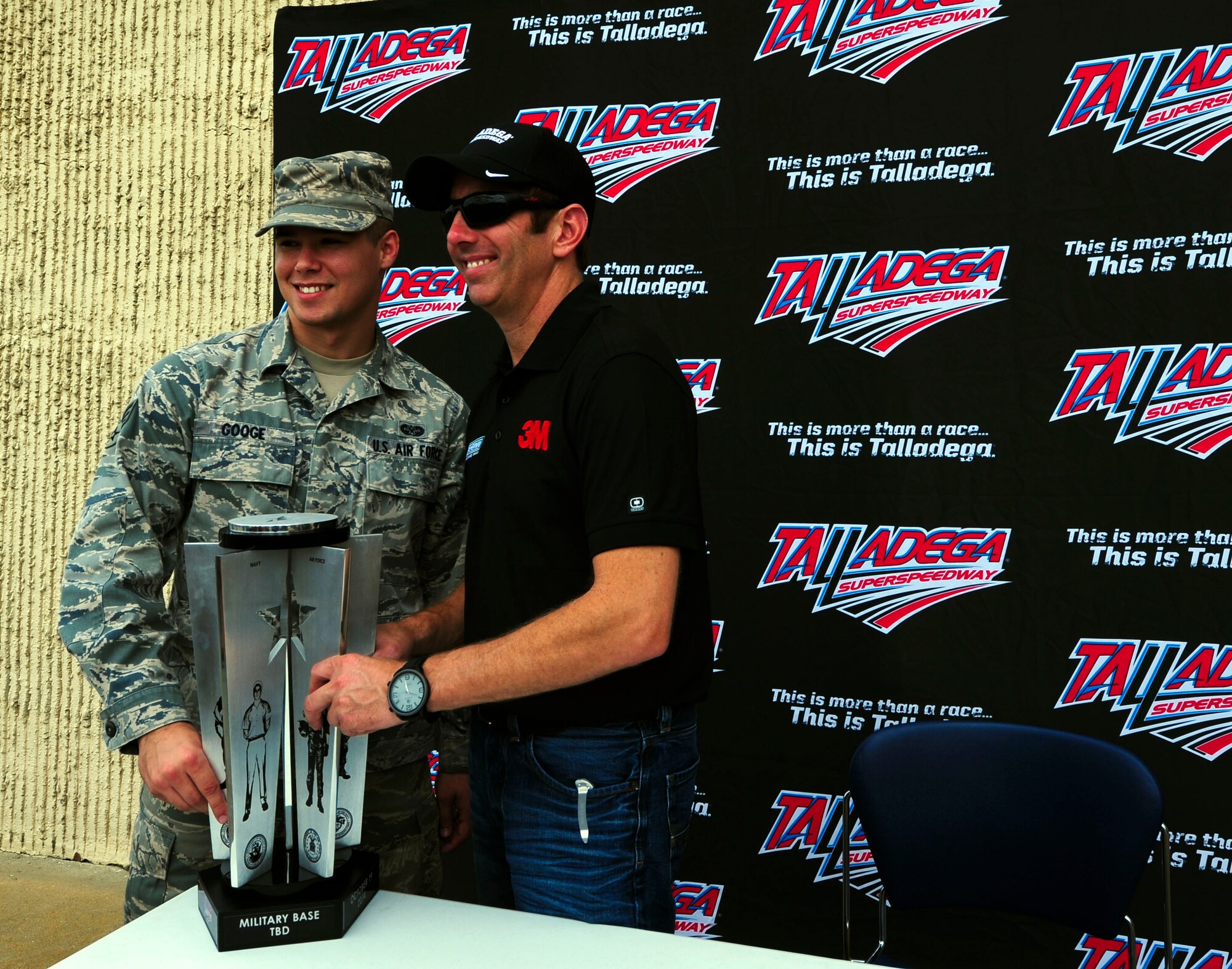 Greg Biffle, NASCAR driver, and Senior Airman Donald Googe Jr., 42nd Air Base Wing paralegal, pose with the Freedom Trophy at Maxwell Air Force Base, Ala., Sep. 25, 2014. Googe is scheduled to present the trophy to the Talladega GEICO 500 winner on victory lane Oct. 19, 2014. (U.S Air Force photo by Airman 1st Class Alexa Culbert)