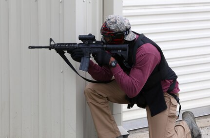 Senior Airman Frank Oliver-Henry, 802nd Security Forces Squadron Tactical Response Team member, provides cover for his team during the force-on-force challenge portion of the Battle of the Badges competition Sept. 27 at Joint Base San Antonio-Randolph’s Camp Talon. Firefighters and security forces members from Joint Base San Antonio locations have competed in Battle of the Badges for the past three years. The initiative was designed to build stronger bonds between the agencies and has become a tradition for the unit members, their families and friends. (U.S. Air Force photo by Johnny Saldivar)