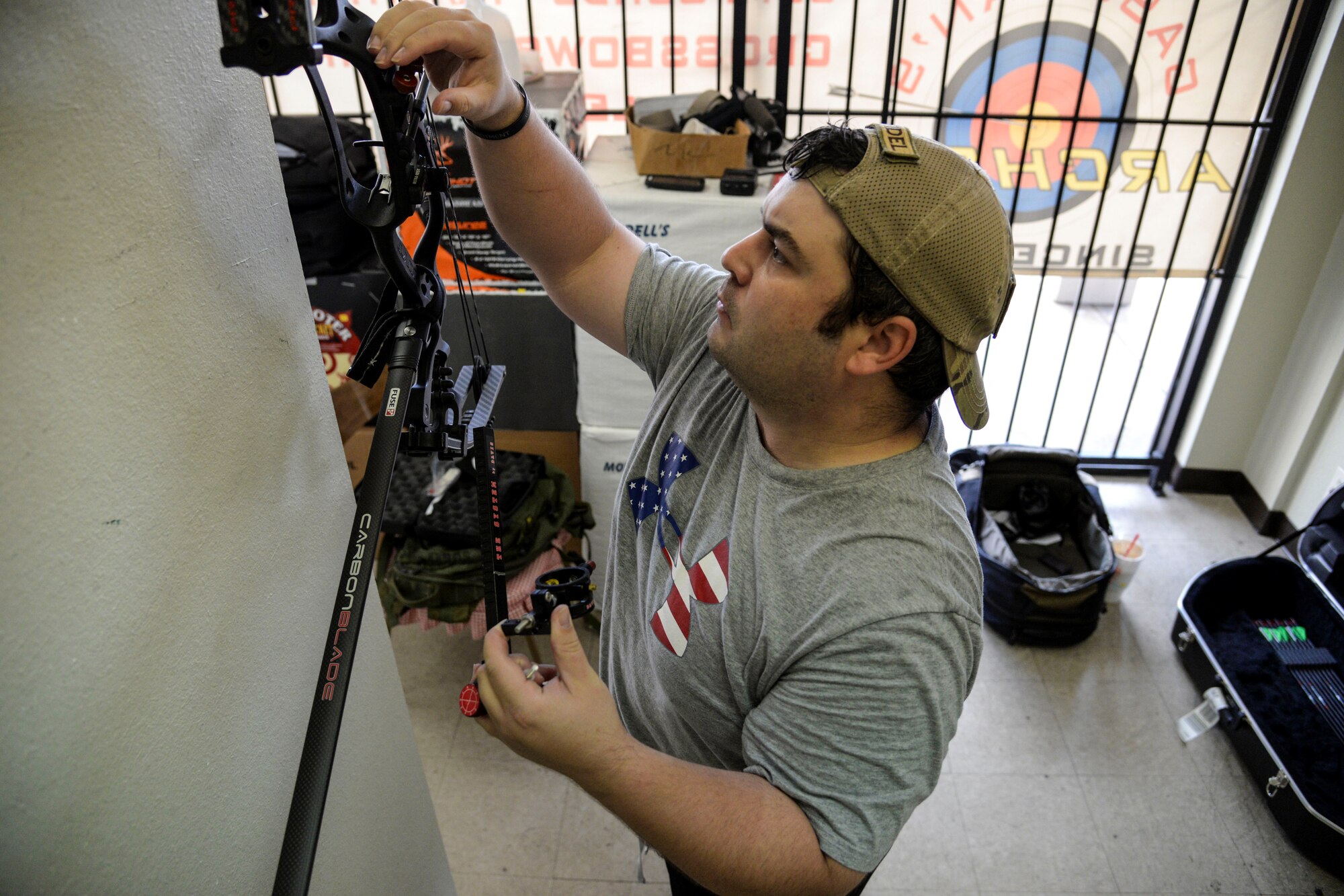 Staff Sgt. Seth Pena mounts a scope to his compound bow Sept. 14, 2014, at a local archery facility in San Antonio. Pena is vying for a spot on the Air Force team competing at the 2014 Warrior Games, taking place from Sept. 28 to Oct. 4, in Colorado Springs, Colorado. Pena is a former tactical control air party member and is now assigned to the 59th Medical Wing's Airman Medical Transition Unit. (U.S. Air Force photo/Senior Airman Michael Ellis)