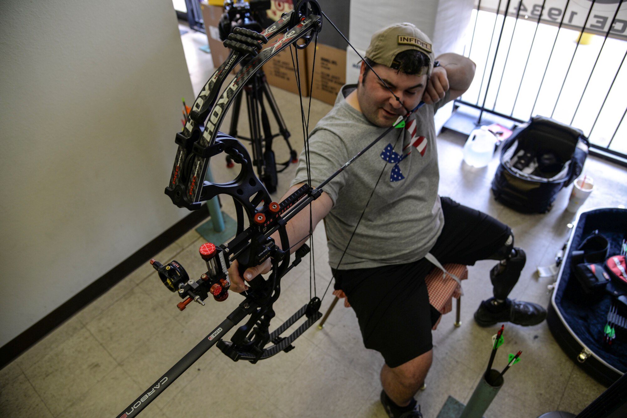 Staff Sgt. Seth Pena readies his compound bow to strike a target 25 meters away Sept. 14, 2014, at a local archery facility in San Antonio. Pena is vying for a spot on the Air Force team competing at the 2014 Warrior Games, taking place from Sept. 28 to Oct. 4, in Colorado Springs, Colorado. Pena is a former tactical control air party member and is now assigned to the 59th Medical Wing's Airman Medical Transition Unit. (U.S. Air Force photo/Senior Airman Michael Ellis)