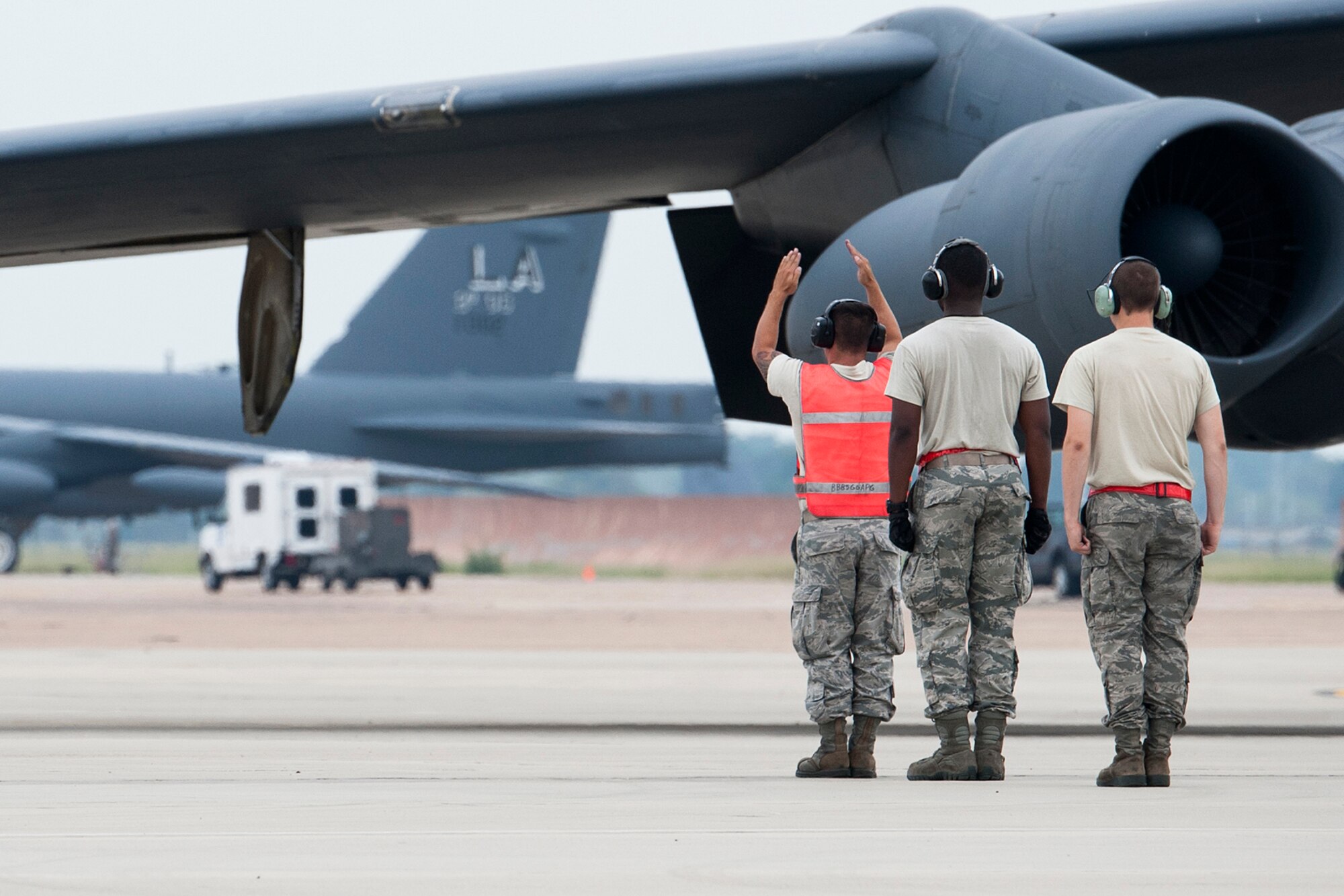 A 2nd Aircraft Maintenance Squadron crew chief marshals a B-52H Stratofortress from its parking spot for a mission on Sept. 18, 2014, Barksdale Air Force Base, La. The aircrew on board the jet are from the 343rd Bomb Squadron, which is assigned to the 307th Bomb Wing and is the only nuclear certified squadron in the Air Force Reserve Command. (U.S. Air Force photo by Master Sgt. Greg Steele/Released)