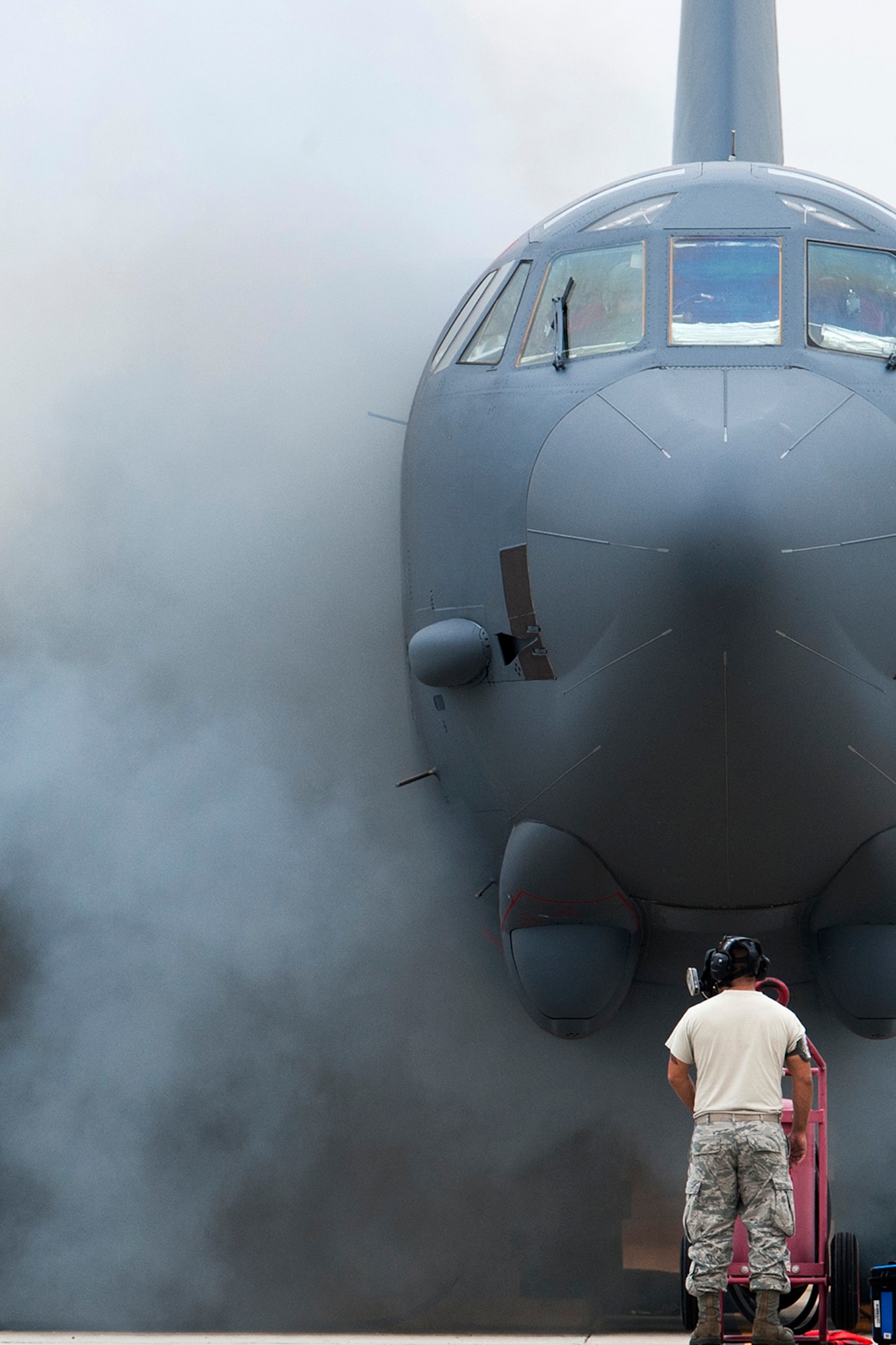 The wing of a B-52H Stratofortress in obscured by smoke after a "cart-start" of its engines, Sept. 18, 2014, Barksdale Air Force Base, La. This type of engine start enables the aircraft to be airborne within minutes and is routine training for maintenance personnel and aircrew. (U.S. Air Force photo by Master Sgt. Greg Steele/Released)