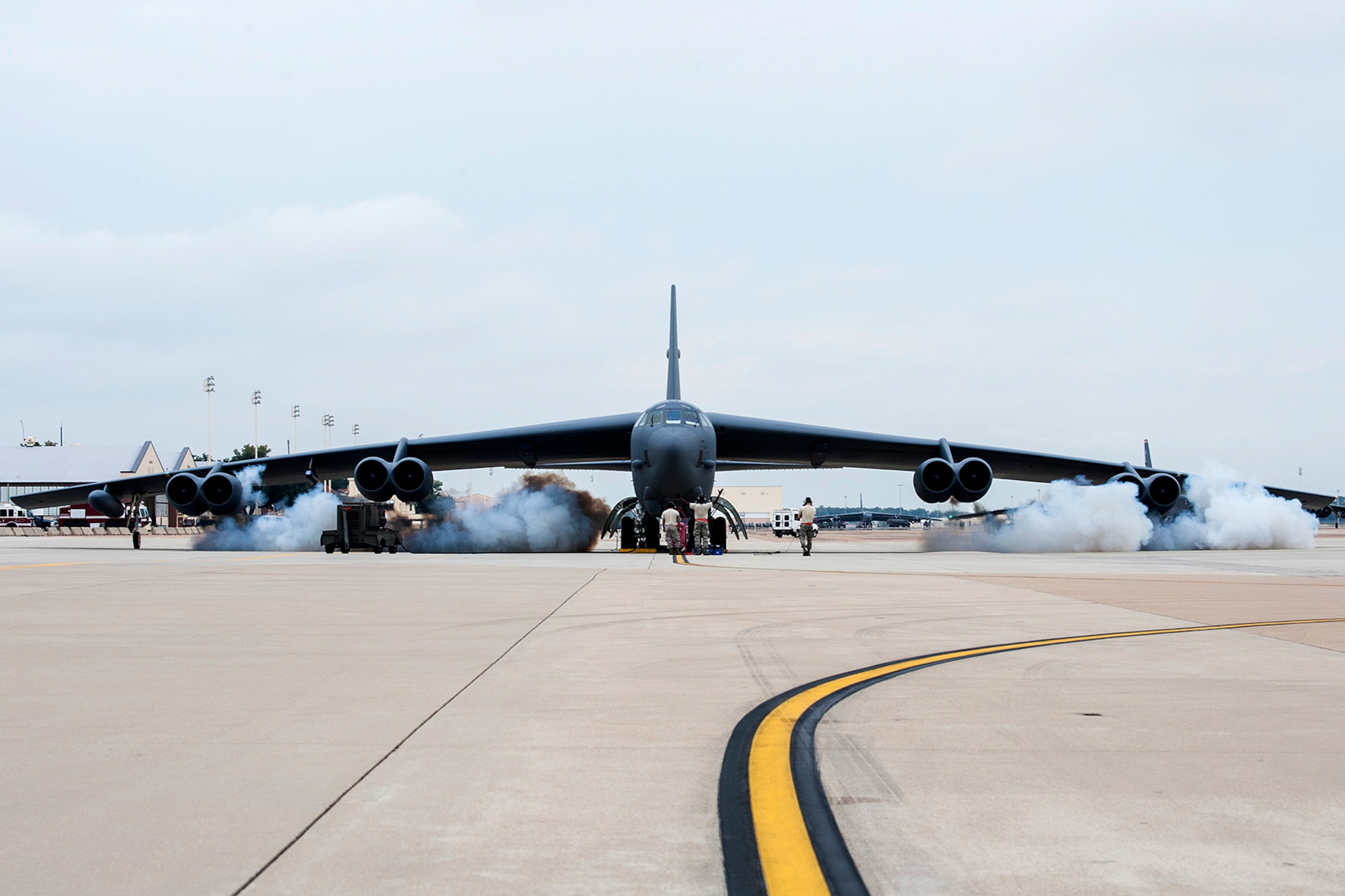 Smoke billows from the engines of a B-52H Stratofortress during a "cart-start", Sept. 18, 2014, Barksdale Air Force Base, La. This type of engine start enables the aircraft to be airborne within minutes and is routine training for maintenance personnel and aircrew. (U.S. Air Force photo by Master Sgt. Greg Steele/Released)