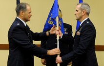 Col. Douglas Drakeley, 655th Intelligence, Surveillance and Reconnaissance Group commander, left, hands the 28th Intelligence Squadron guideon to its newly installed commander, Lt. Col. Joseph Marcinek, during the squadron's activation and assumption of command ceremony Sept. 24, 2014 at Hurlburt Field, Fla.  The 919th Special Operations Wing will provide continuous support to the Hurlburt-based Air Force Reserve unit in the areas of financial management, military pay and force support.  (U.S. Air Force photo/Senior Airman Christopher Callaway) 