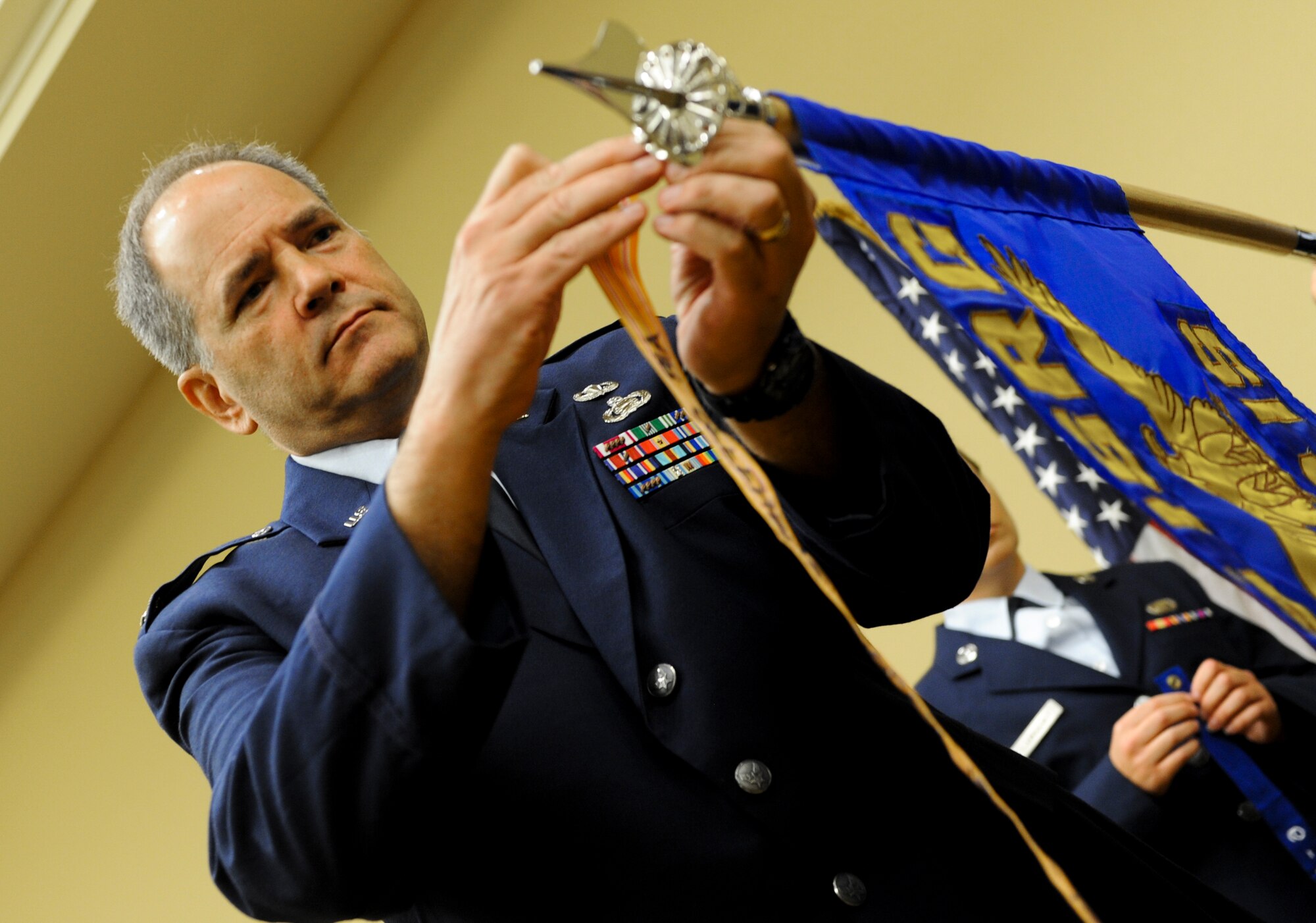 Col. Douglas Drakeley, 655th Intelligence, Surveillence and Reconnaissance Group commander, adds a campaign streamer to the 28th Intelligence Squadron guideon as he presides over his subordinate unit's activation ceremony Sept. 24, 2014 at Hurlburt Field, Fla.  The 919th Special Operations Wing will provide continuous support to the Hurlburt-based Air Force Reserve unit in the areas of financial management, military pay and force support.  (U.S. Air Force photo/Senior Airman Christopher Callaway) 