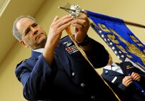 Col. Douglas Drakeley, 655th Intelligence, Surveillence and Reconnaissance Group commander, adds a campaign streamer to the 28th Intelligence Squadron guideon as he presides over his subordinate unit's activation ceremony Sept. 24, 2014 at Hurlburt Field, Fla.  The 919th Special Operations Wing will provide continuous support to the Hurlburt-based Air Force Reserve unit in the areas of financial management, military pay and force support.  (U.S. Air Force photo/Senior Airman Christopher Callaway) 