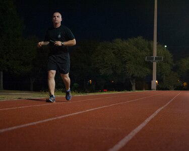 The 6th Annual Prisoners of War and Missing in Action Remembrance Run began at 8:00 a.m. September 18, 2014 and continued for 24 hours. Staff Sgt. George Daggett, a basic military training instructor from the 737th Training Squadron, runs with the baton at the Warhawk Fitness Center track. The batons are presented to former POW /MIAs and their families at the closing ceremony Sept. 19. (U.S. Air Force photo by Amn Justine Rho) 