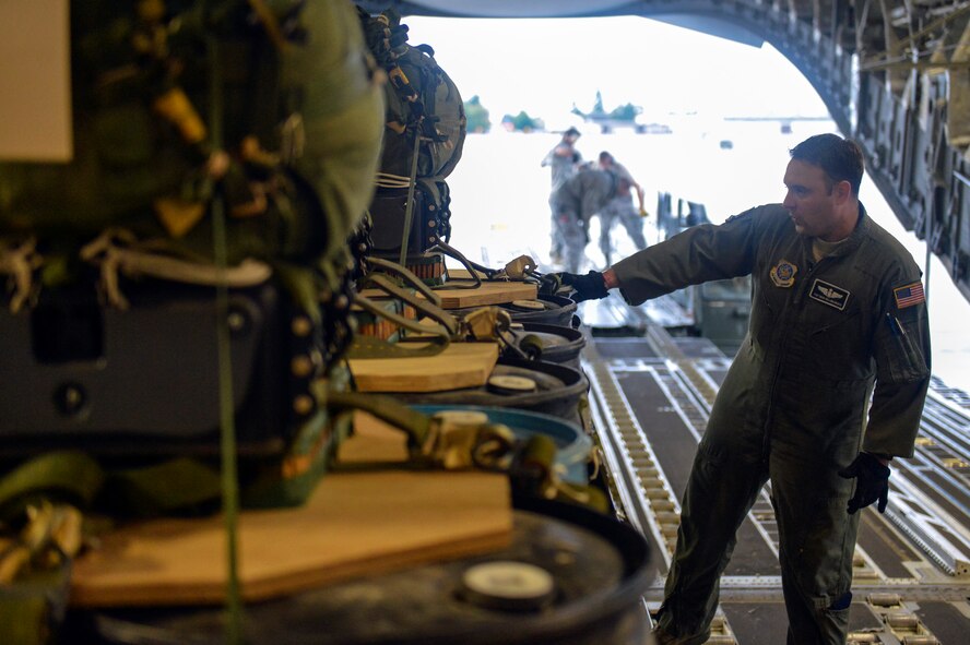 Tech. Sgt. Doug Hollingsworth, 8th Airlift Squadron loadmaster, conducts a pre-airdrop inspection September 25, 2014, after three joint precision airdrop system bundles were loaded onto a C-17 Globemaster III aircraft during a training mission at Joint Base Lewis-McChord, Wash. The training mission included an in-flight refueling, three JPADS drops and an assault landing at Moses Lake, Wash. (U.S. Air Force photo/Staff Sgt. Russ Jackson)