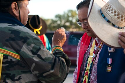 Orevie Longhorn, left, blesses E.J. Flores before the gourd dance and reveille ceremony during the Texas American Indian Heritage Day at Joint Base San Antonio-Randolph Sept. 26. The Texas American Indian Heritage Day events were sponsored by JBSA-Randolph's Native American Heritage Committee. American Indian Heritage Day in Texas, signed into law in 2013, recognizes historical, cultural and social contributions of American Indian communities and leaders of Texas. (U.S. Air Force photo/Desiree N. Palacios)