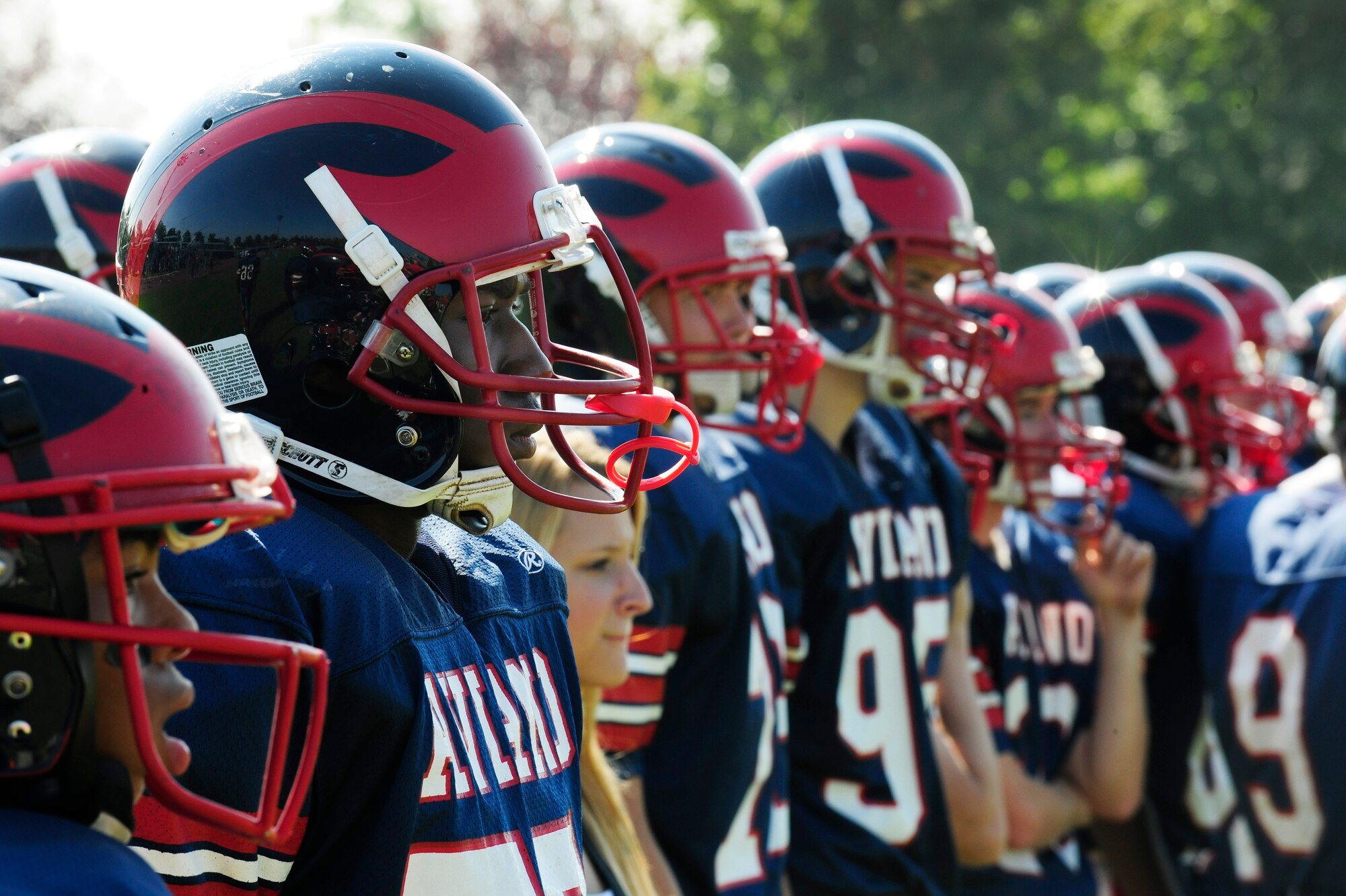 The Aviano High School Saints football team waits on the sidelines during their homecoming game, Sept. 27, 2014, at Aviano Air Base, Italy. Aviano defended their home field, defeating the AFNORTH Lions 38-22. (U.S. Air Force photo/Airman 1st Class Ryan Conroy) 