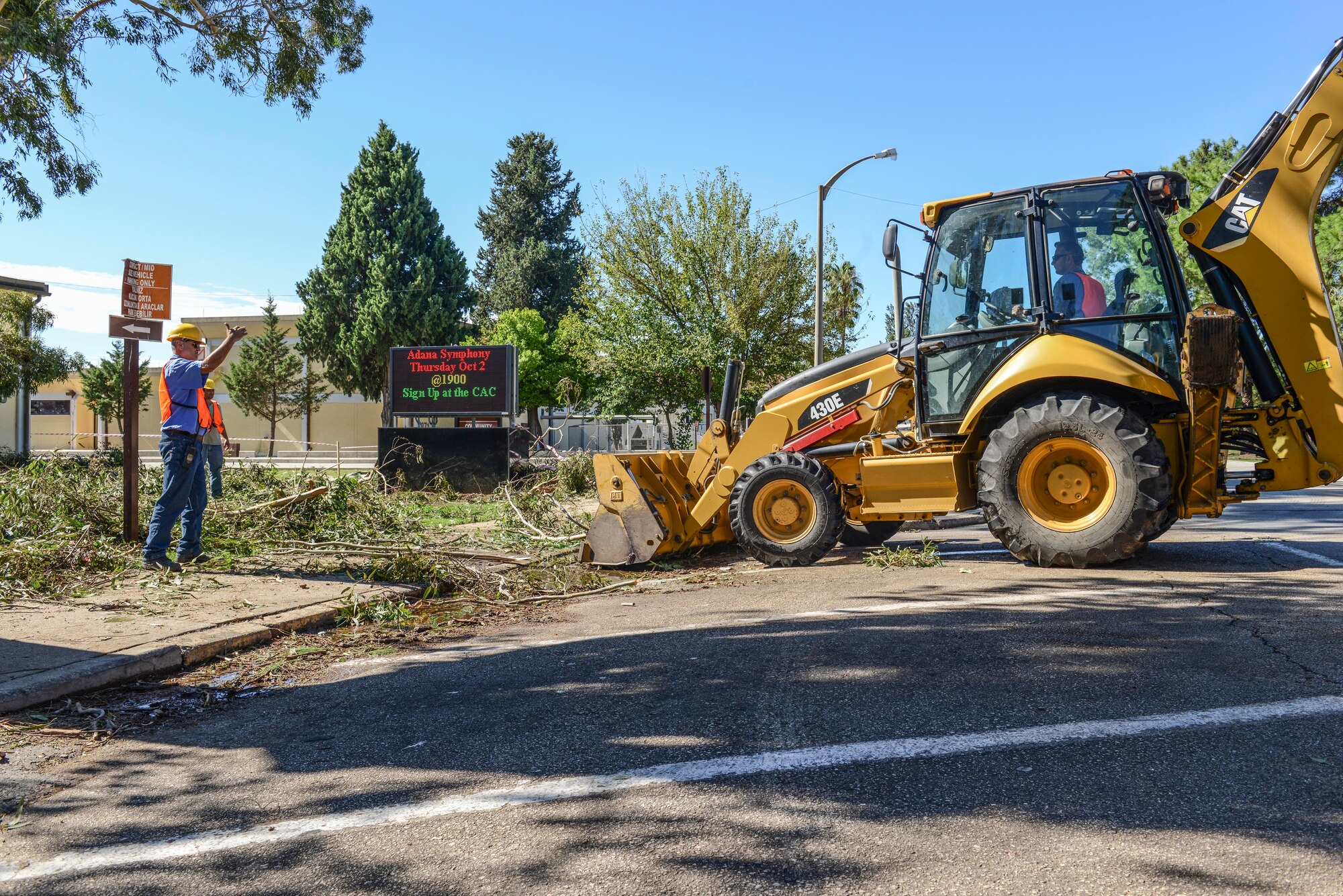Contractors from the 39th Civil Engineer Squadron clean up debris after a storm Sept. 29, 2014, Incirlik Air Base, Turkey. The storm brought severe winds that ripped trees to the ground and left debris all over the base. (U.S. Air Force photo by Staff Sgt. Eboni Reams/Released) 