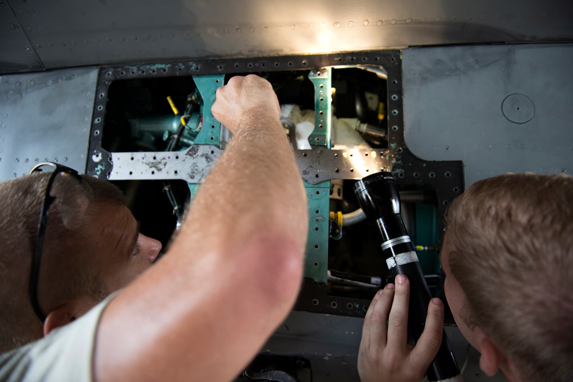 U.S. Air Force F-15 Eagle crew chiefs from the 67th Aircraft Maintenance Unit work together to repair a faulty component on a jet on Kadena Air Base, Japan, Sept. 16, 2014. Sept. 29, 2014, marks the 35th anniversary of the F-15Cs arrival to Kadena. While most people don't maintain a personal vehicle for more than 10 years, the Air Force maintainers and operators here have ensured the safe operation of theF-15C and D models stationed at Kadena for 35 years with countless, thorough inspections and repairs. (U.S. Air Force photo by Senior Airman Maeson L. Elleman/Released)