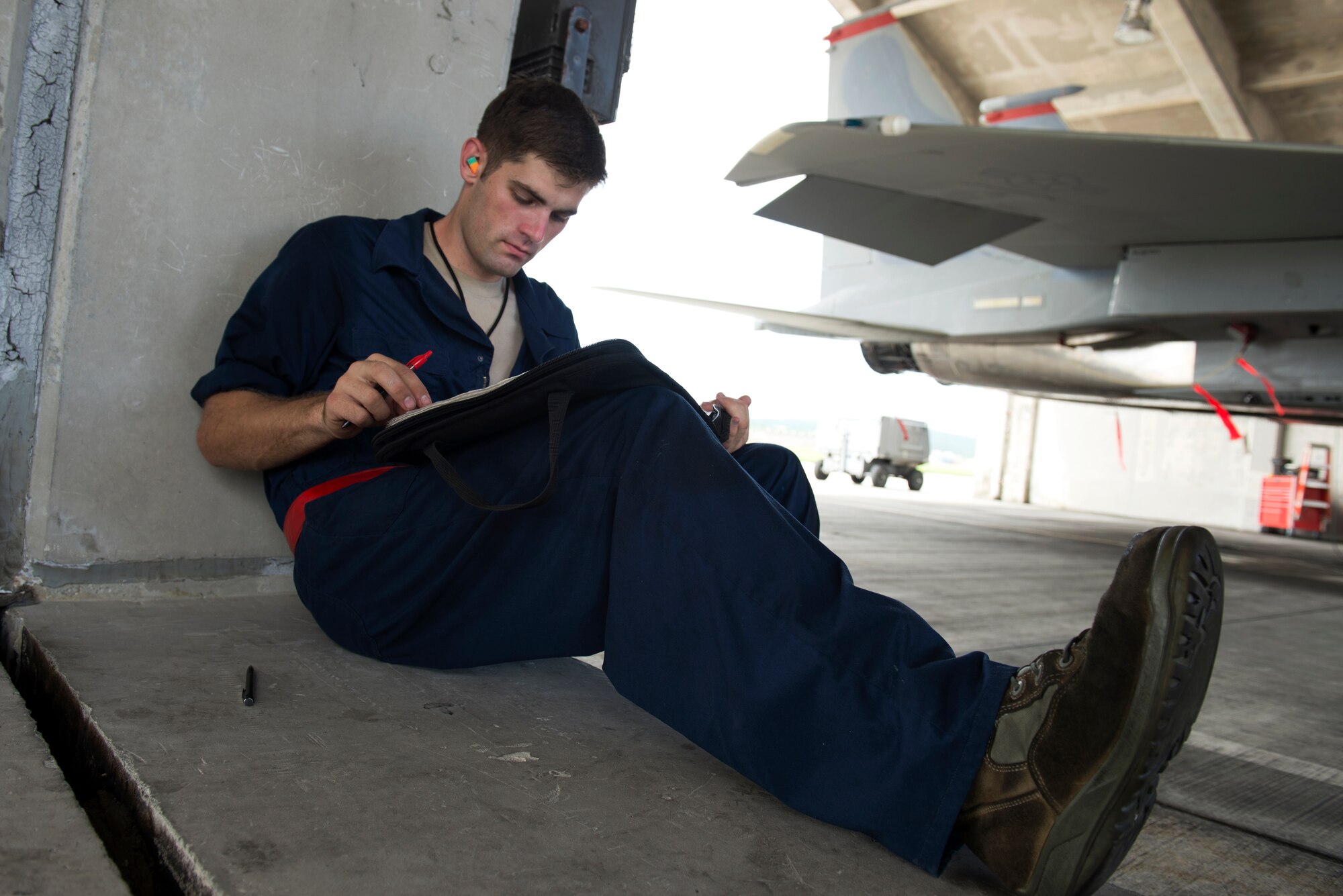 U.S. Air Force Senior Airman Dillon Gross, 67th Aircraft Maintenance UUnit F-15 Eagle crew chief, transcribes discrepancies from an F-15C on Kadena Air Base, Japan, Sept. 16, 2014. Sept. 29, 2014, marksthe 35th anniversary of the F-15Cs arrival to Kadena. While most people don't maintain a personal vehicle for more than 10 years, the Air Force maintainers and operators here have ensured the safe operation of the F-15C and D models stationed at Kadena for 35 years with countless, thorough inspections and repairs. (U.S. Air Force photo by Senior Airman Maeson L. Elleman/Released)
