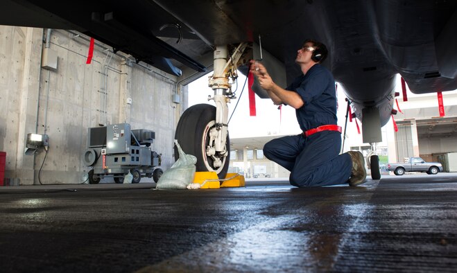 U.S. Air Force Senior Airman Dillon Gross, 67th Aircraft Maintenance Unit F-15 Eagle crew chief, replaces a panel on an F-15C on Kadena Air Base, Japan, Sept. 16, 2014. The F-15C first arrived on Kadena 35 years ago. Without diligent repairs and inspections on the jets by Airmen within the 18th Aircraft Maintenance Group, it's unlikely any of the jets would have been flying half as long as they have. (U.S. Air Force photo by Senior Airman Maeson L. Elleman/Released)