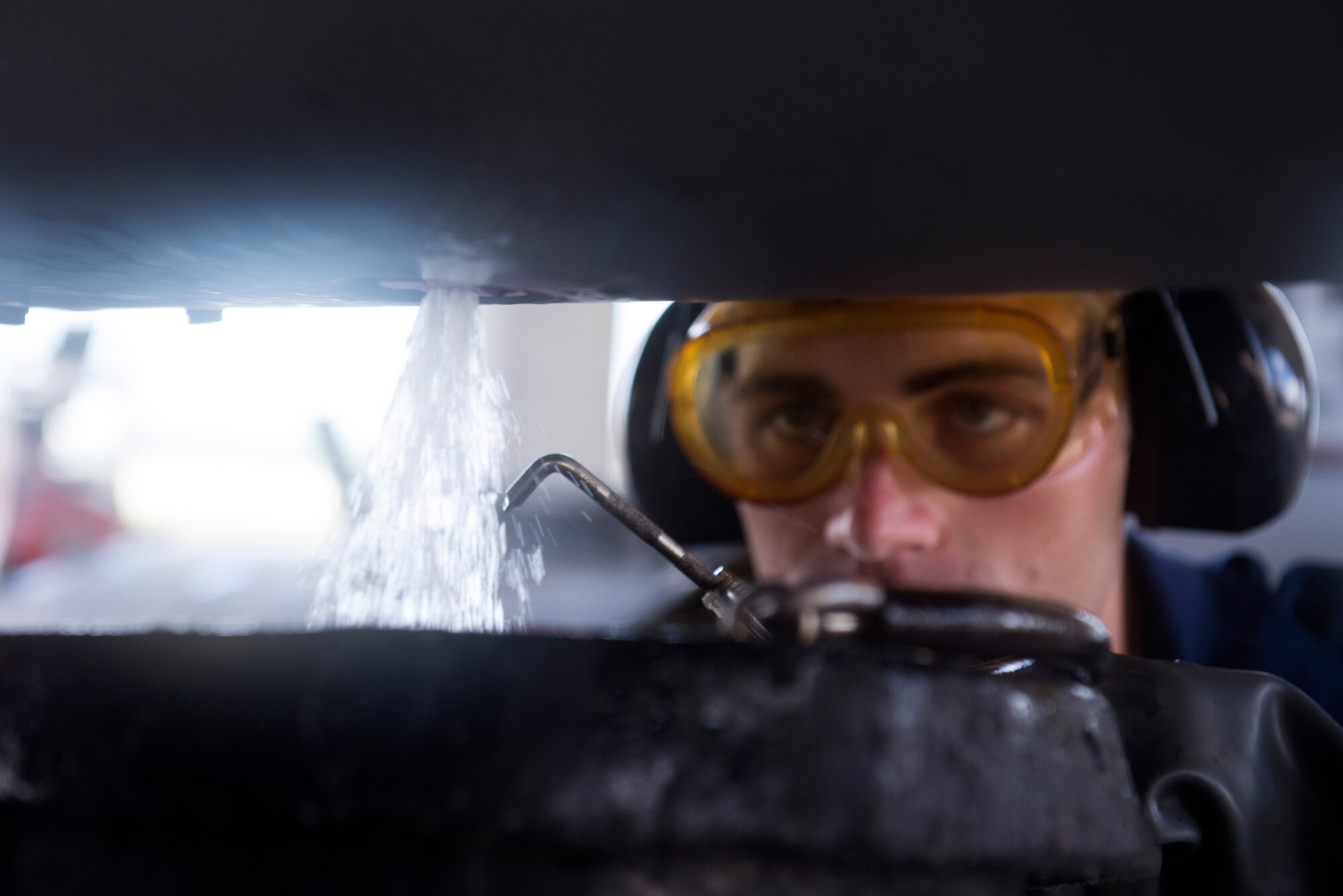 U.S. Air Force Senior Airman Dillon Gross, 67th Aircraft Maintenance Unit F-15 Eagle crew chief, drains JP-8 jet fuel from an F-15C on Kadena Air Base, Japan, Sept. 16, 2014. The F-15C first arrived on Kadena 35 years ago. Without diligent repairs and inspections on the jets by Airmen within the 18th Aircraft Maintenance Group, it's unlikely any of the jets would have been flying half as long as they have. (U.S. Air Force photo by Senior Airman Maeson L. Elleman/Released)