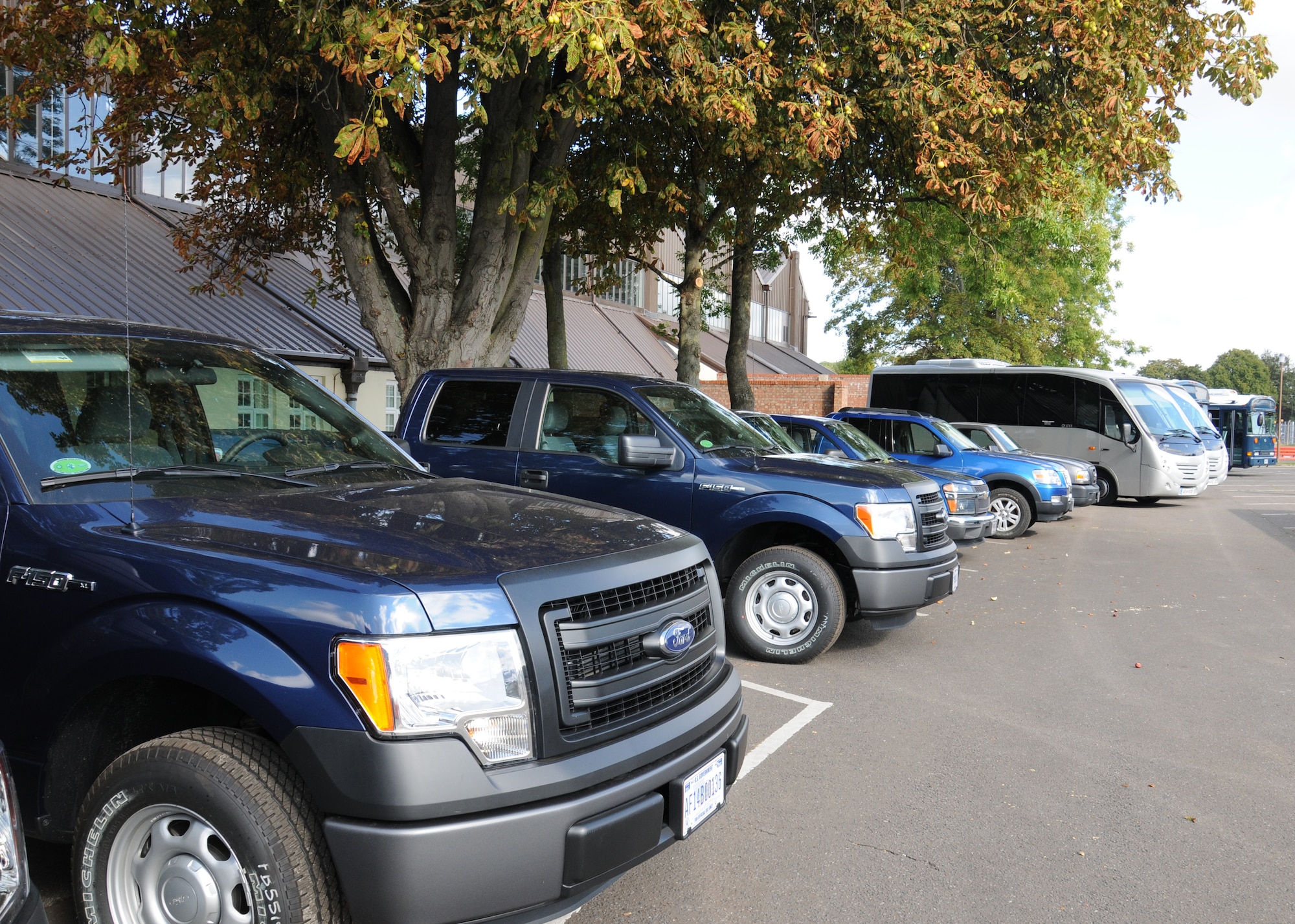 Government-owned vehicles line the parking lot of Bldg. 582 Sept. 12, 2014, on RAF Mildenhall, England. The distribution section has many vehicles including forklifts and buses, so there is going to be more parking to provide adequate space for these vehicles. (U.S. Air Force photo/Gina Randall/Released) 