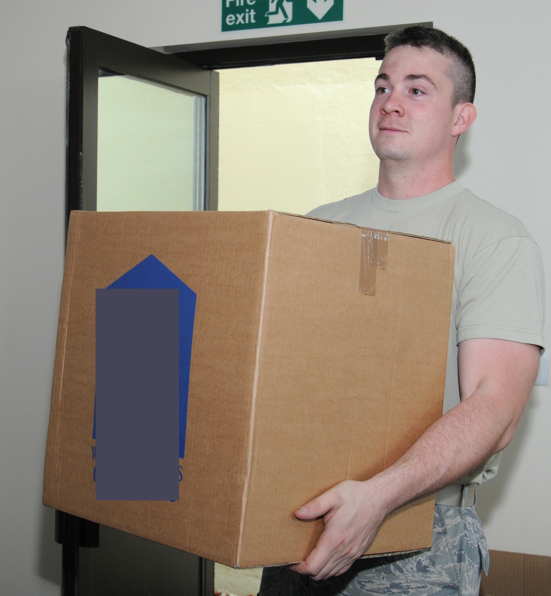 U.S. Air Force Staff Sgt. Ryin Rader, 100th Logistics Readiness Squadron NCO in charge of equipment support from Keyser, W.Va., moves boxes Sept. 8, 2014, on RAF Mildenhall, England. The team worked together to move locations in one day so they could be up and running to assist customers as soon as possible. (U.S. Air Force photo/Gina Randall/Released)