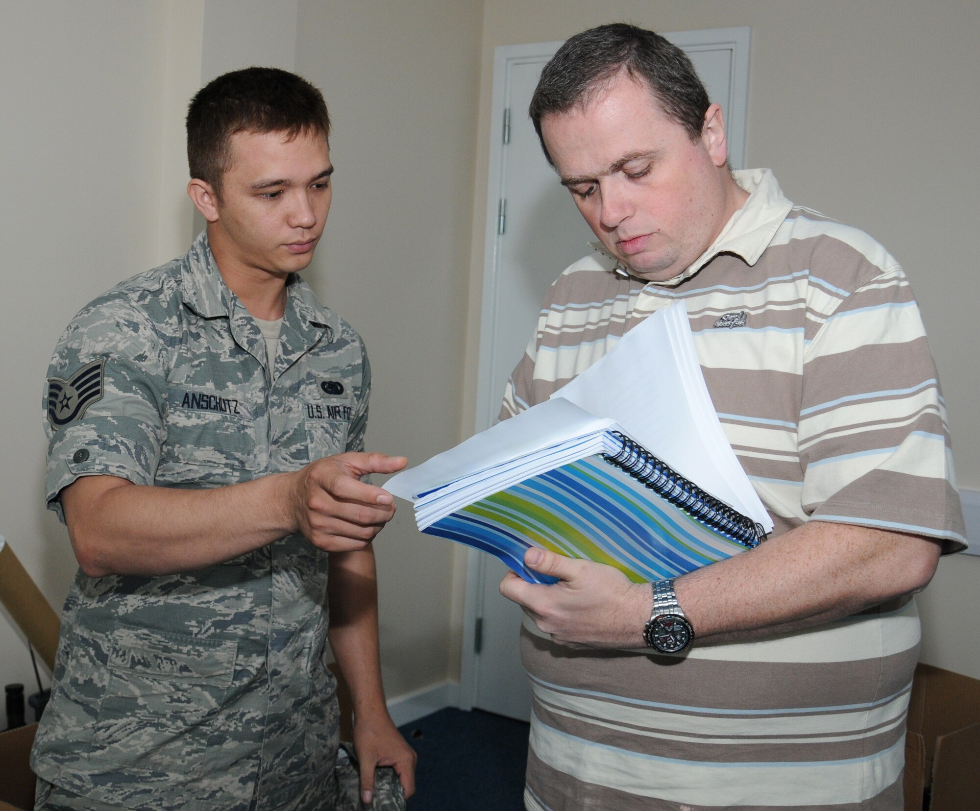 U.S. Air Force Staff Sgt. Richard Anschutz, left, from Navarre, Fla., and Nicholas Waddick, from London, both 100th Logistics Readiness Squadron computer administrators, organize office computer ports Sept. 8, 2014, on RAF Mildenhall, England. Anschutz and Waddick were vital to the distribution section building move as the section is a customer support operation and can’t be without communication for any time. (U.S. Air Force photo/Gina Randall/Released)