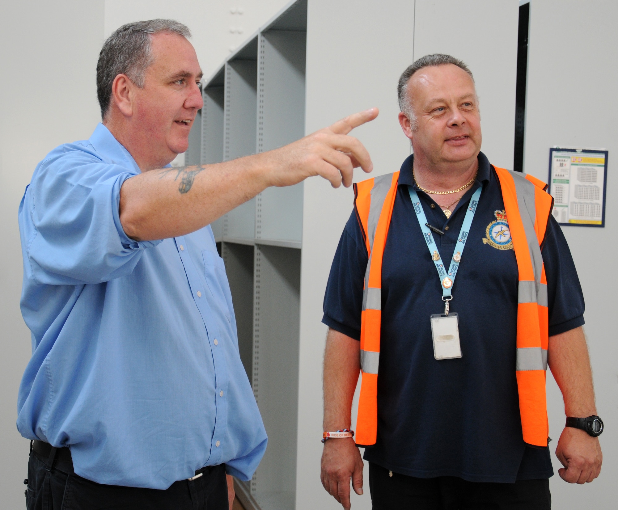 Michael Cooper, left, 100th Logistics Readiness Squadron chief dispatcher from Dublin, Ireland, and Jerry Dove, 100th LRS vehicle operator, discuss where to move parts and office supplies Sept. 8, 2014, on RAF Mildenhall, England. The cargo movement and vehicle operations elements have joined together in one building to streamline the process of moving personnel and cargo. (U.S. Air Force photo/Gina Randall/Released)