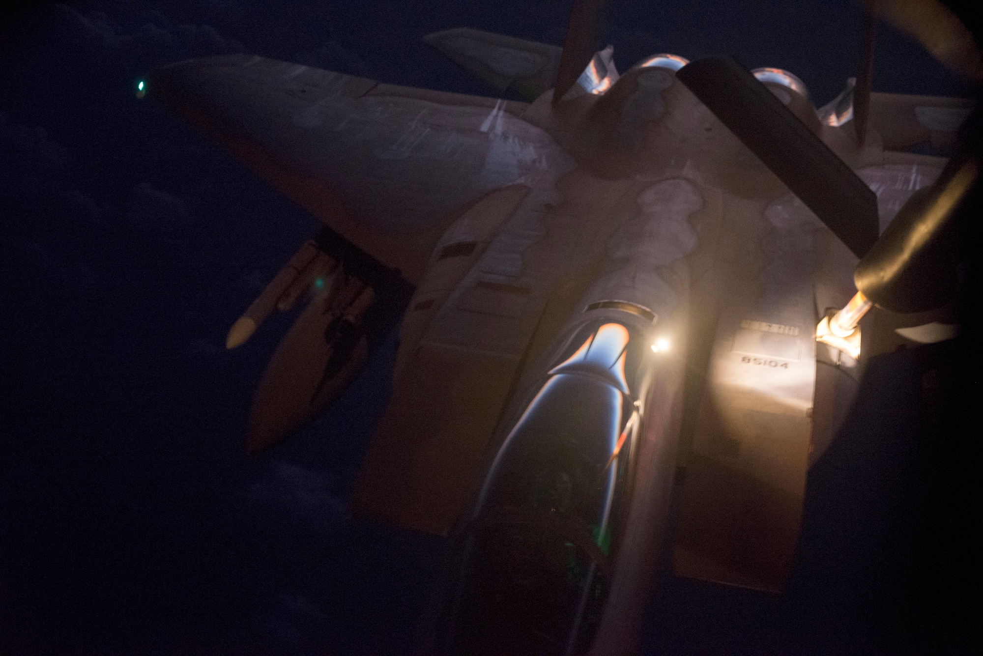 A U.S. Air Force F-15C Eagle refuels from a 909th Air Refueling Squadron KC-135 Stratotanker over the ocean late at night Sept. 16, 2014. Sept. 29, 2014, marks the 35th anniversary of the F-15C's arrival to Kadena. At Kadena alone, the F-15C/D squadrons, the 67th, 44th and formerly 12th Fighter Squadrons, have earned the title of best Air Force fighter squadron of the year and the prestigious Raytheon Trophy, formerly the Hughes Trophy, nine times since the aircraft's arrival 35 years ago. (U.S. Air Force photo by Senior Airman Maeson L. Elleman/Released)