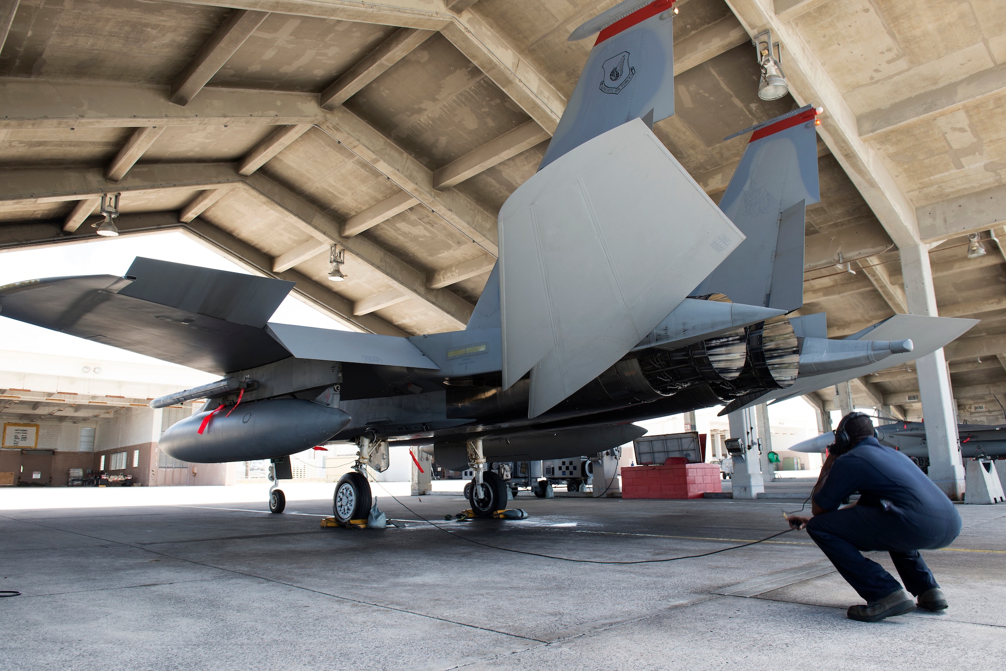 A U.S. Air Force F-15 Eagle crew chief from the 67th Aircraft Maintenance Unit watches pre-flight procedures and communicates with the aircraft's pilot before takeoff on Kadena Air Base, Japan, Sept. 16, 2014. Sept. 29, 2014, marks the 35th anniversary of the F-15C's arrival to Kadena. With a perfect record of more than 100 confirmed kills and no combat losses in operations and contingencies ranging from Turkey and Bosnia to Iraq and Afghanistan, the Eagle has proven itself time and again. (U.S. Air Force photo by Senior Airman Maeson L. Elleman/Released)