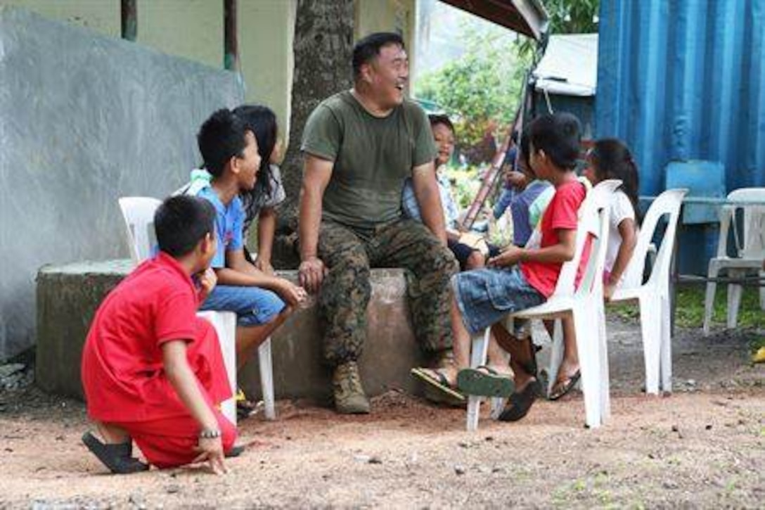 May 10, 2014 Legazpi, Bicol, Philippines - U.S. Navy Petty Officer 2nd Class Lee Halls, a corpsman with 9th Engineer Support Battalion, interacts with locals during exercise Balikatan 2014 in Guinobatan, Philippines, April 22, 2014. The project is one of five engineering civic action program missions by Joint Civil Military Operations Task Force units in support of BK14. This year marks the 30th iteration of the exercise, which is an annual Republic of the Philippines-U.S. military bilateral training exercise and humanitarian civic assistance engagement. (U.S. Marine Corps photo by Lance Cpl. Trever Statz/) 
