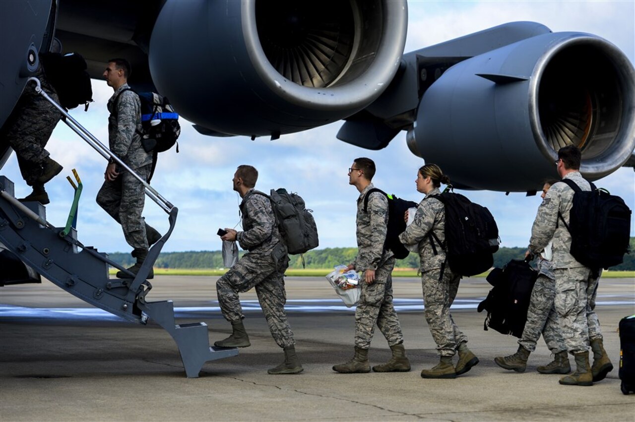 Airmen assigned to the 633rd Medical Group board a C-17 Globemaster at Langley Air Force Base, Va., Sept. 26, 2014. The 633rd Medical Group packaged and delivered a modular medical treatment center, as part of a governmentwide effort to support humanitarian relief operations in Ebola-stricken African nations. U.S. Air Force photo by Senior Airman Kayla Newman