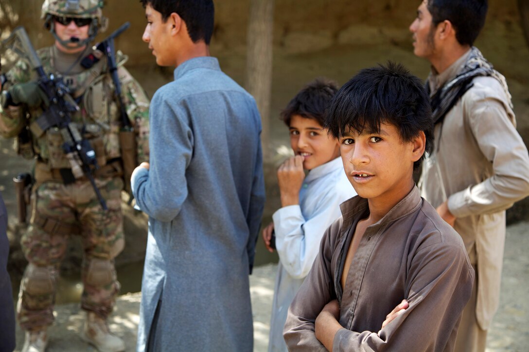 U.S. Army Capt. Eric Leatherman, left, meets and talks with Afghan villagers while on a patrol in Sayghani village in Parwan province, Afghanistan, Sept. 27, 2014. Leatherman is commander of the 454th Engineer Company Route Clearance.