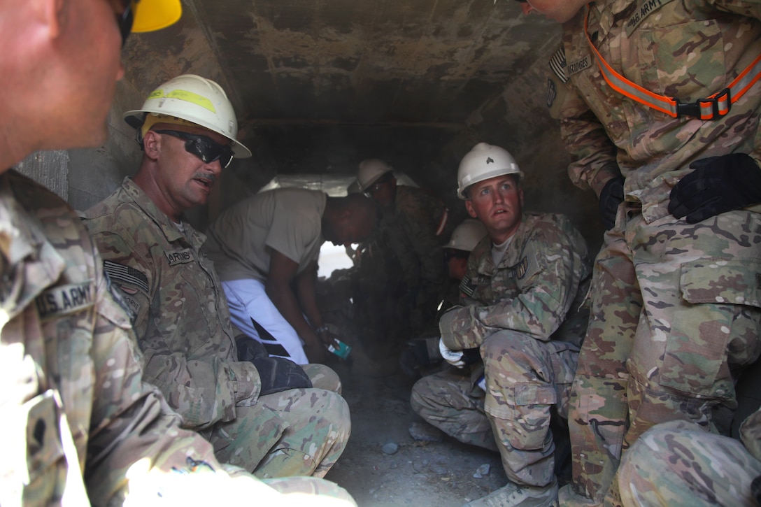 U.S. soldiers take cover after an indirect fire attack on Bagram Airfield, Afghanistan, Sept. 26, 2014. The soldiers are combat engineers assigned to the 304th Engineer Company and 961st Engineer Company.