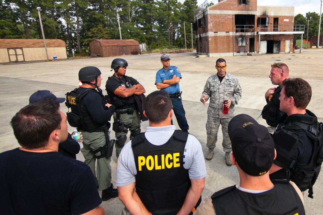 Air Force Master Sgt. Jose Almeida, center right, instructs airmen and law enforcement officers on ways to carry injured people during tactical combat casualty care training on the Anthony Canale Training Center in Egg Harbor Township, N.J., Sept. 19, 2014. The course included students assigned to the New Jersey National Guard's 177th Security Forces Squadron, the 227th Air Support Operations Squadron and numerous police officers from southern New Jersey.  Almeida is a joint terminal attack controllers
instructor assigned to the New Jersey National Guard's 227th Air Support Operations Squadron, 177th Fighter Wing.