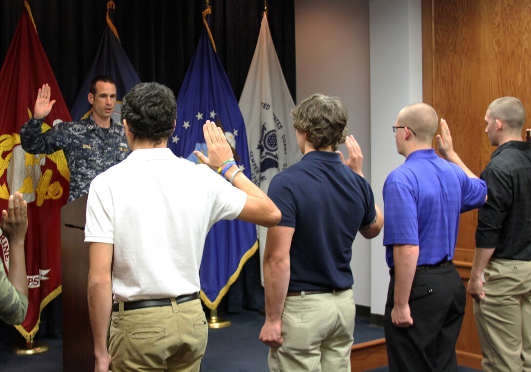 U.S. Navy Lt. Jason Doan, Military Entrance Processing Station Ft. Lee operations officer, administers the Oath of Enlistment to five of the seven Marine Corps applicants who enlisted on the 13th anniversary of Sept. 11, 2001. After years of the Global War on Terror, new recruits enlist to serve their nation almost every day.  (U.S. Marine Corps photo by Cpl. Aaron Diamant/Released)