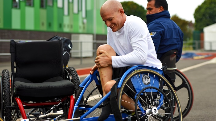 U.S. Marine Corps Staff Sergeant Jacob Rich prepares to practice for the 100m Men's Wheel event for the 2014 Invictus Games at Mayesbrooks Training Center in London, Sept. 10, 2014. The Invictus Games is an opportunity for wounded, ill, and injured service members from around the world to recover and rehabilitate through competing in adaptive sports.