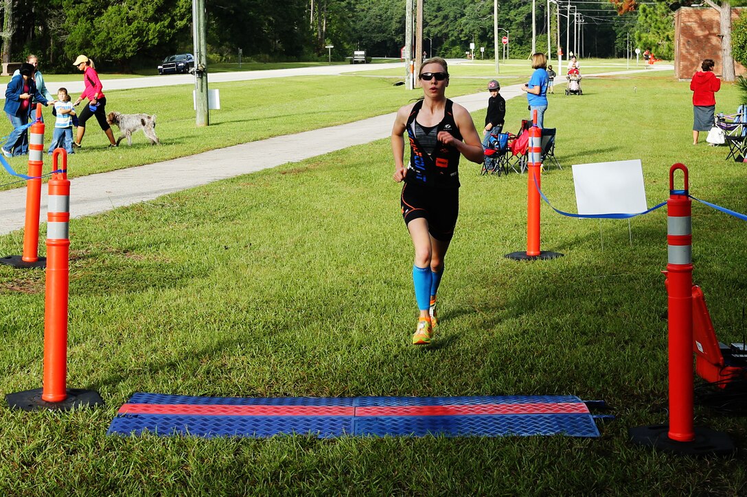 Sarah K. Horn crosses the finish line of Marine Corps Community Services’ Sprint Duathlon/Relay after running six miles and biking 10 at Marine Corps Air Station Cherry Point, N.C., Sept. 27, 2014. Horn, a native of Milwaukee, was the first-place female competitor, finishing with a time of one hour and 16 minutes. 